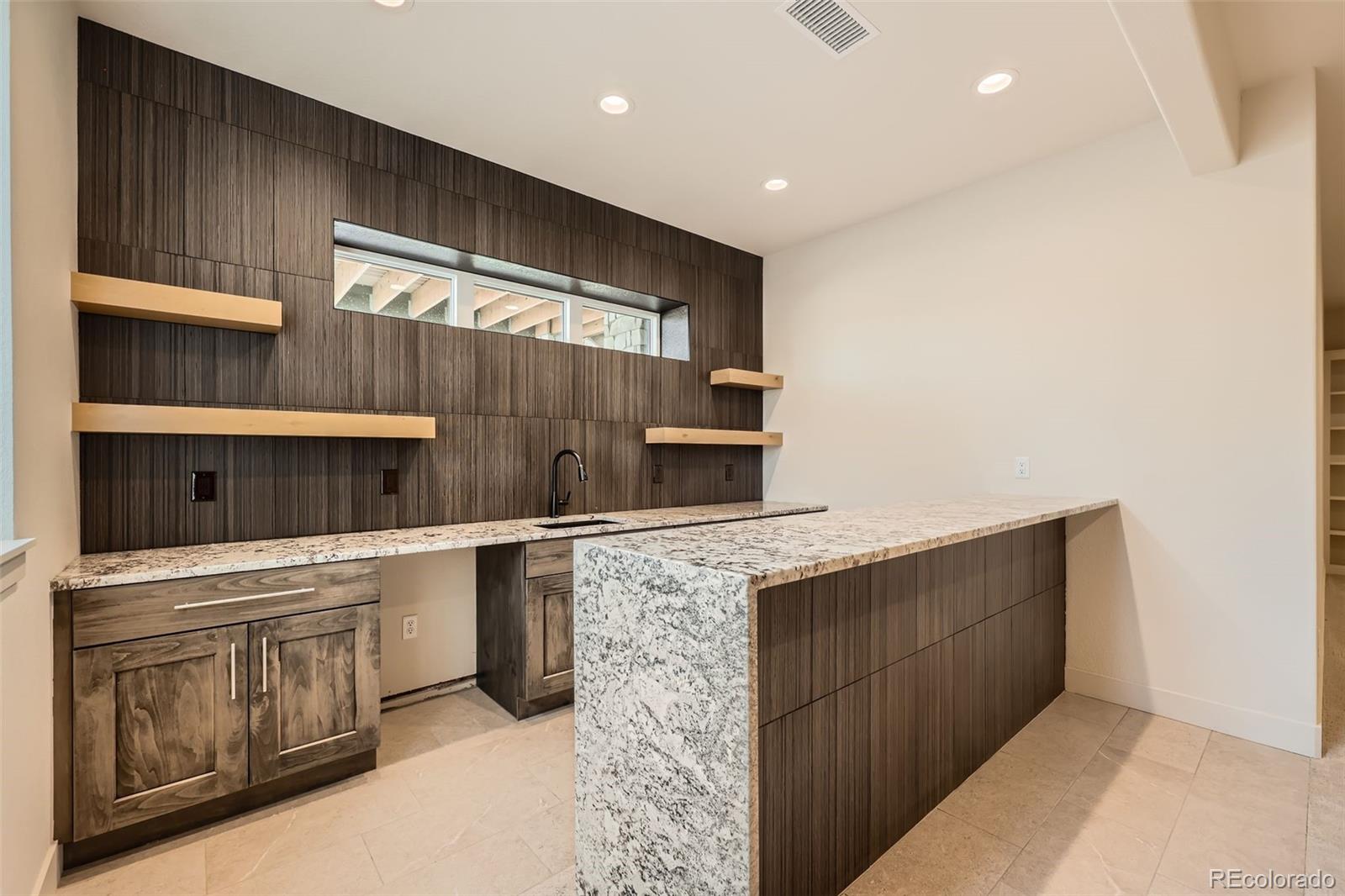 5841 Powell Road Parker, CO 80134 - Photo 34 of 50 a kitchen with stainless steel appliances a cabinets and counter space