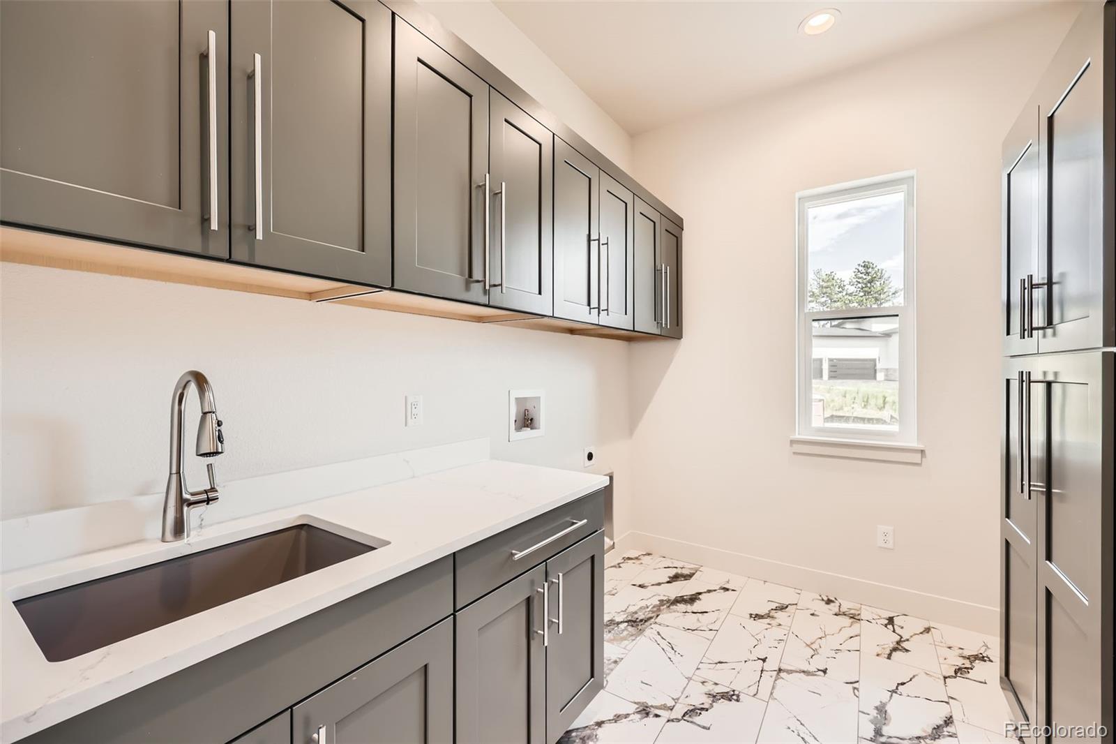 5841 Powell Road Parker, CO 80134 - Photo 39 of 50 a kitchen with a sink and cabinets