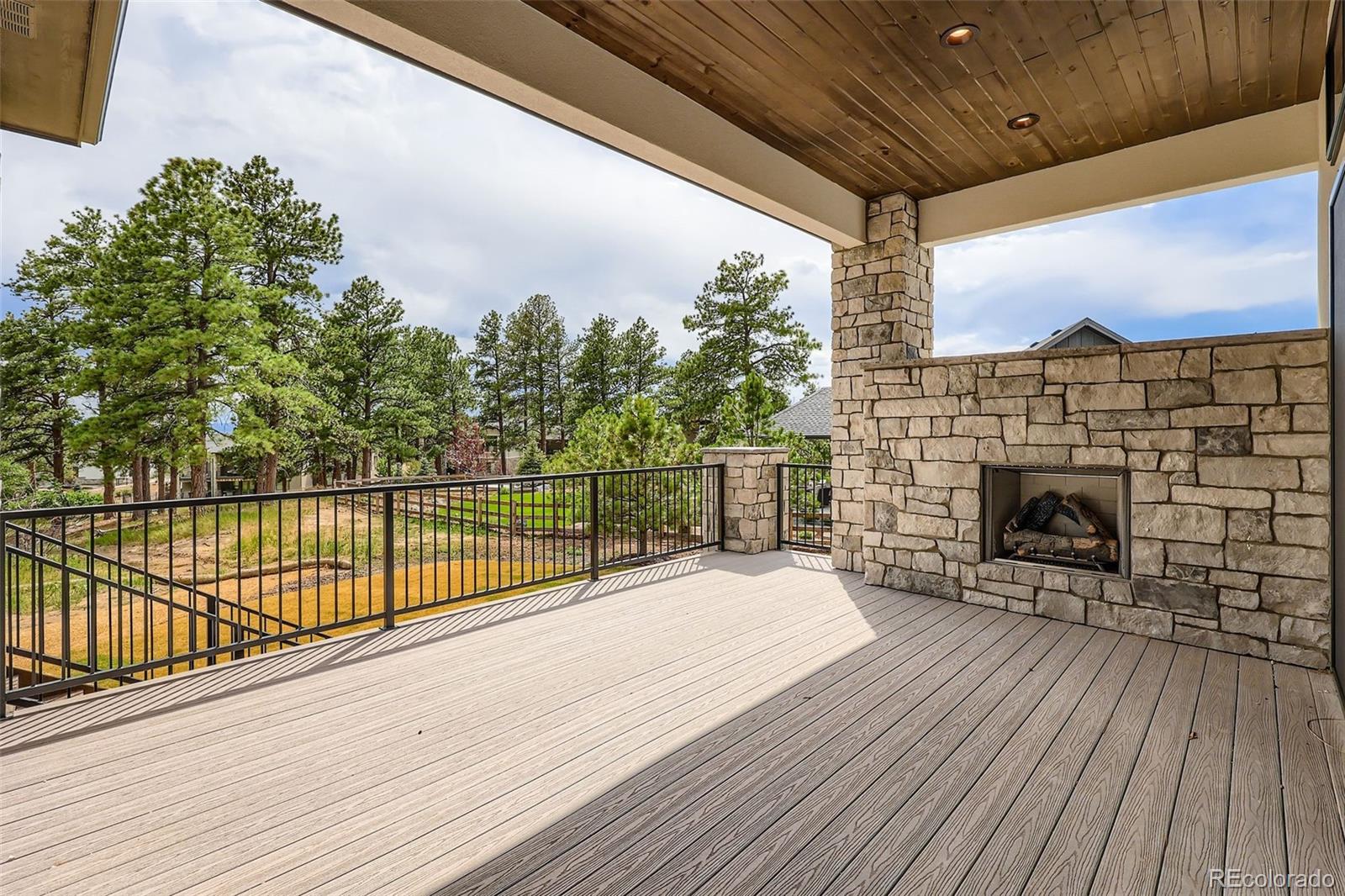 5841 Powell Road Parker, CO 80134 - Photo 42 of 50 a view of a balcony with a floor to ceiling window next to a wooden fence