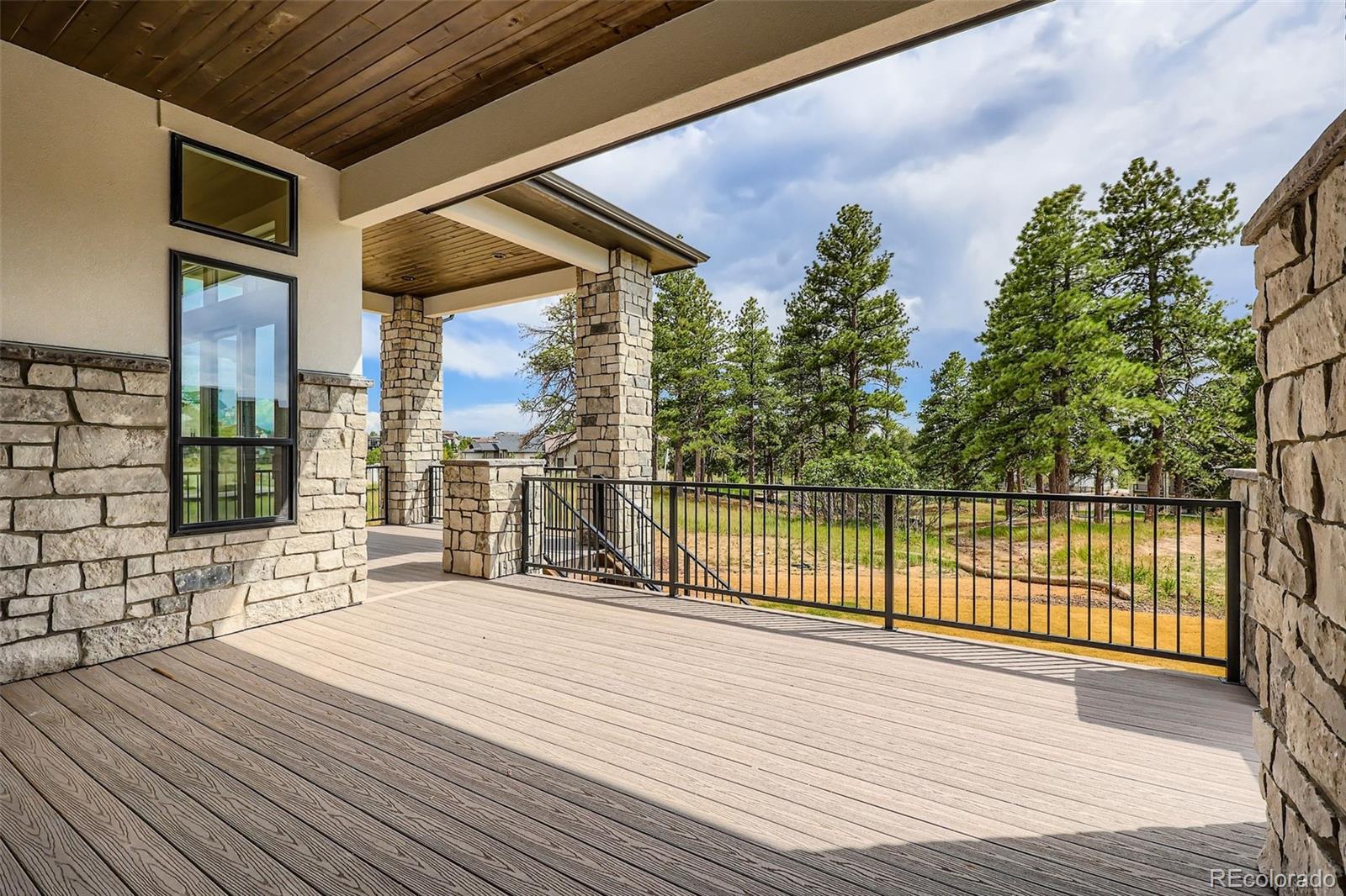 5841 Powell Road Parker, CO 80134 - Photo 43 of 50 a view of a balcony with wooden floor