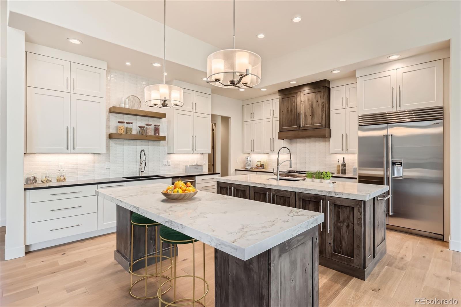 5841 Powell Road Parker, CO 80134 - Photo 46 of 50 a kitchen with a stove a refrigerator and a kitchen island