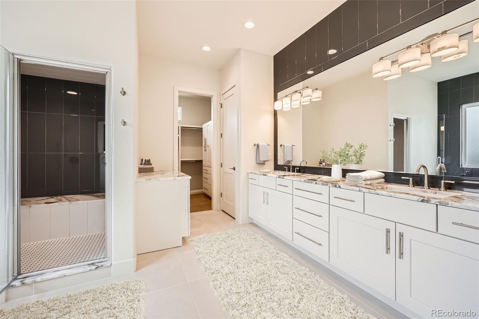 5841 Powell Road Parker, CO 80134 - Photo 49 of 50 a large bathroom with a glass door shower and sink
