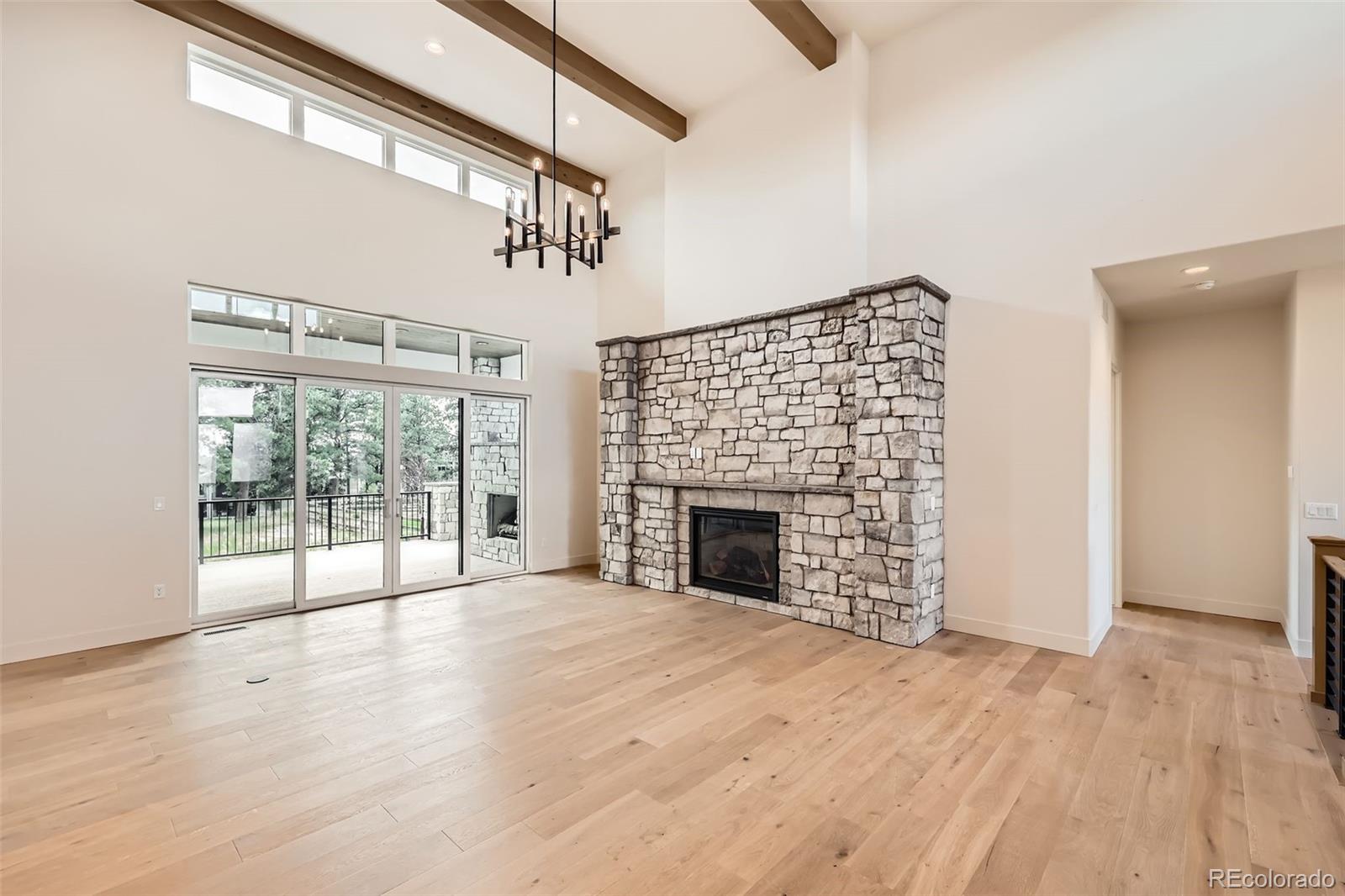 5841 Powell Road Parker, CO 80134 - Photo 6 of 50 a view of empty room with wooden floor and fireplace