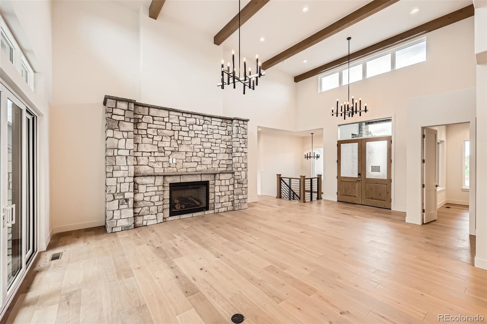 5841 Powell Road Parker, CO 80134 - Photo 8 of 50 a view of an empty room with wooden floor fireplace and a window