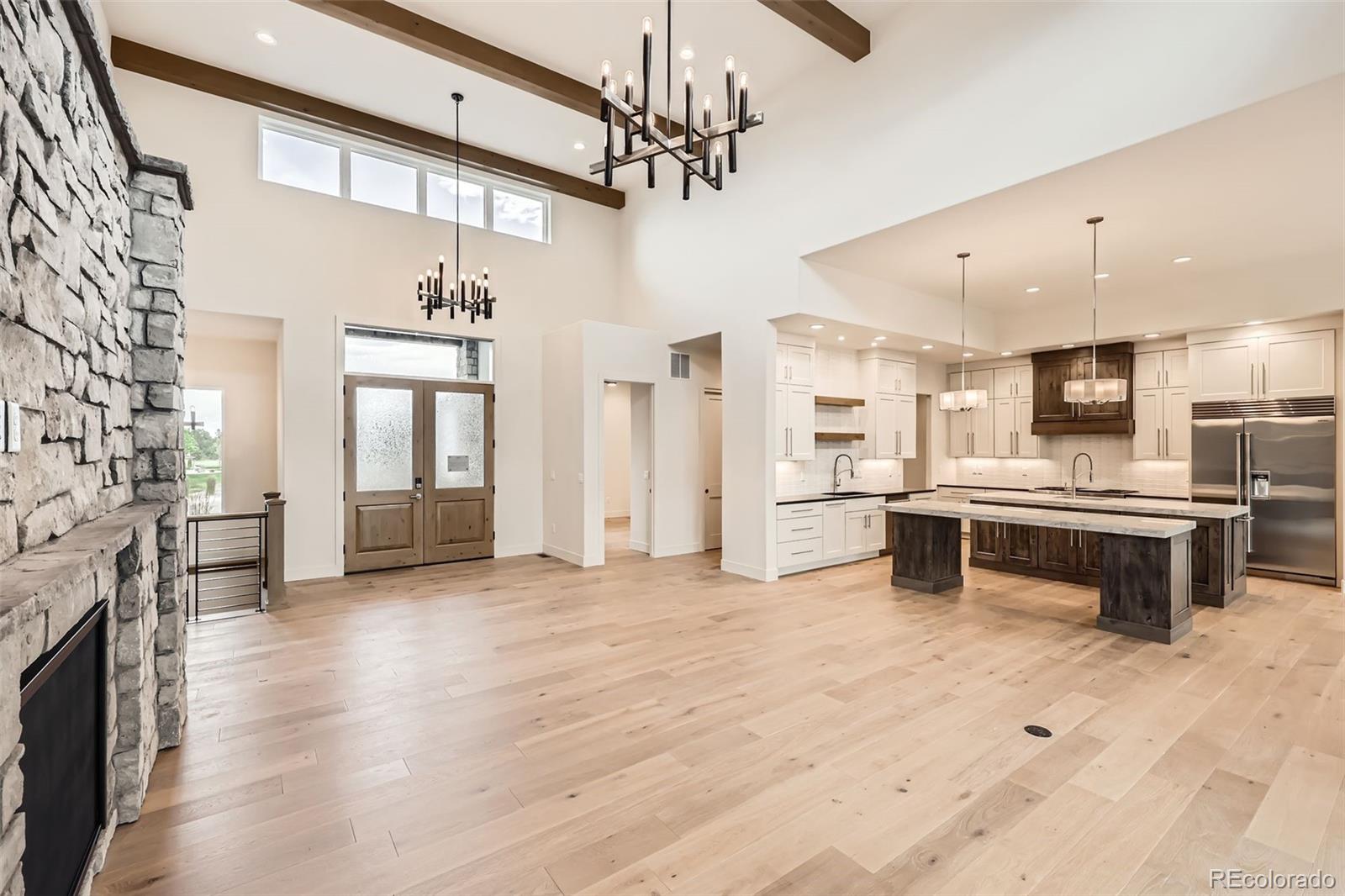 5841 Powell Road Parker, CO 80134 - Photo 9 of 50 a large white kitchen with a sink and dishwasher a stove top oven with wooden floor