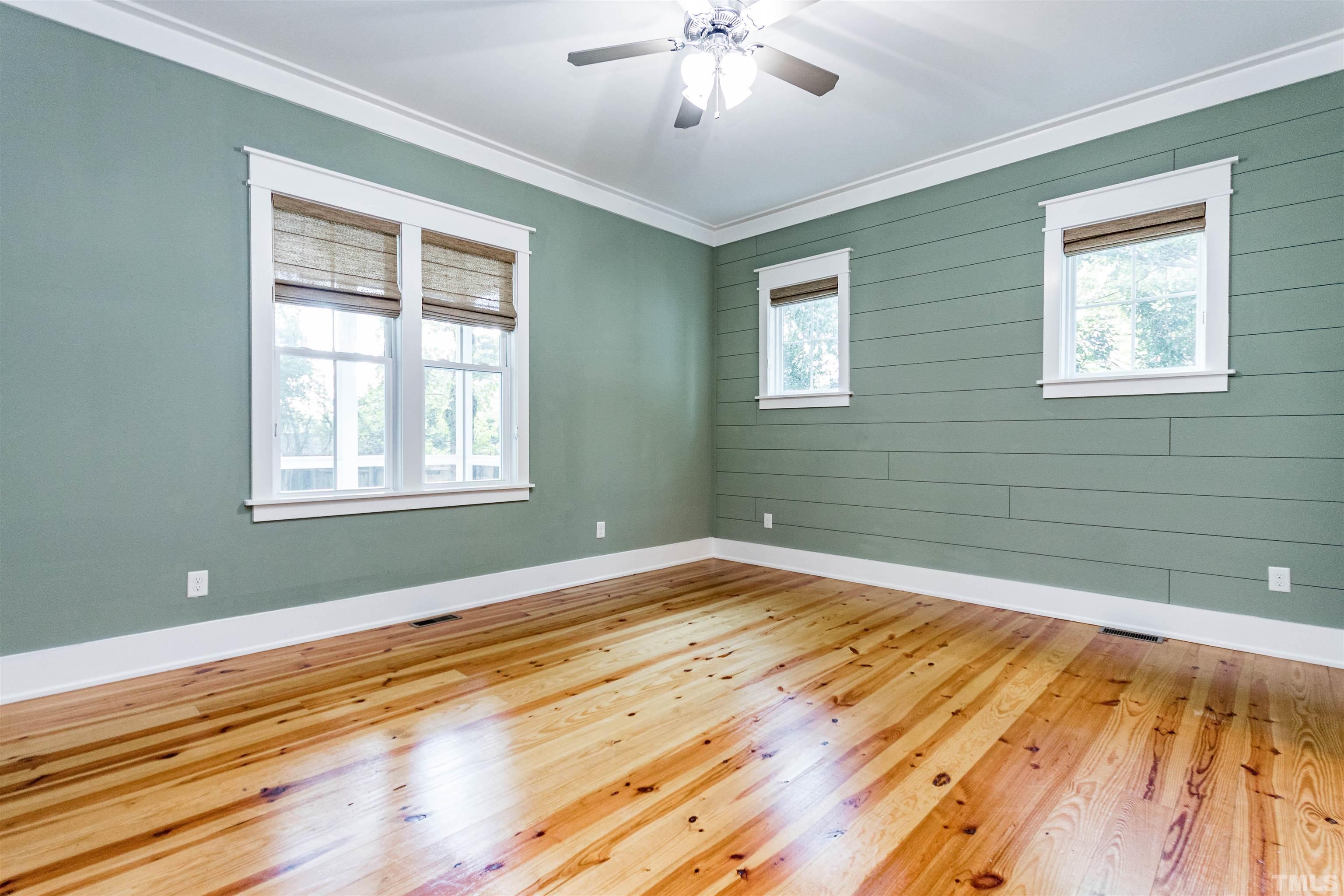 610 New Road Raleigh, NC 27608 - Photo 13 of 24 a view of empty room with wooden floor and fan