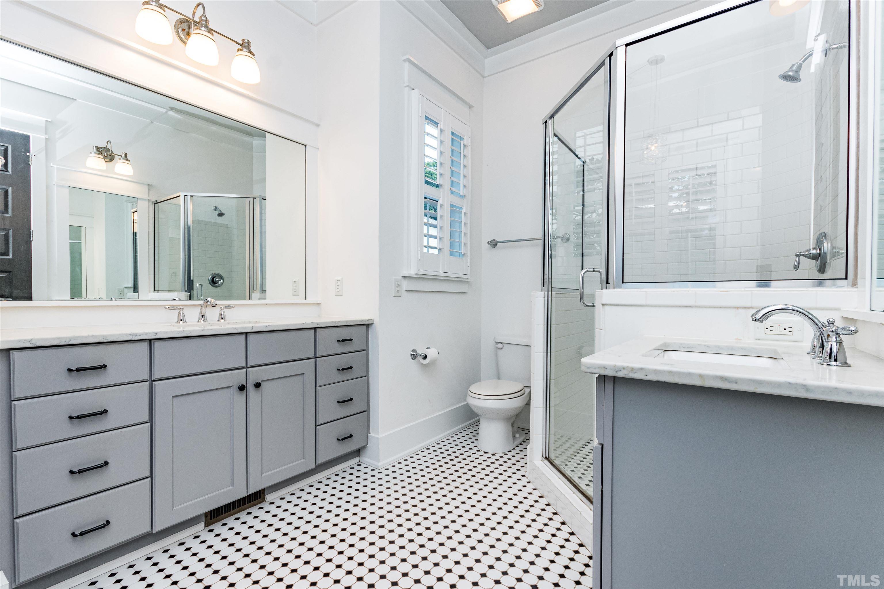 610 New Road Raleigh, NC 27608 - Photo 15 of 24 a bathroom with a sink a toilet and a mirror