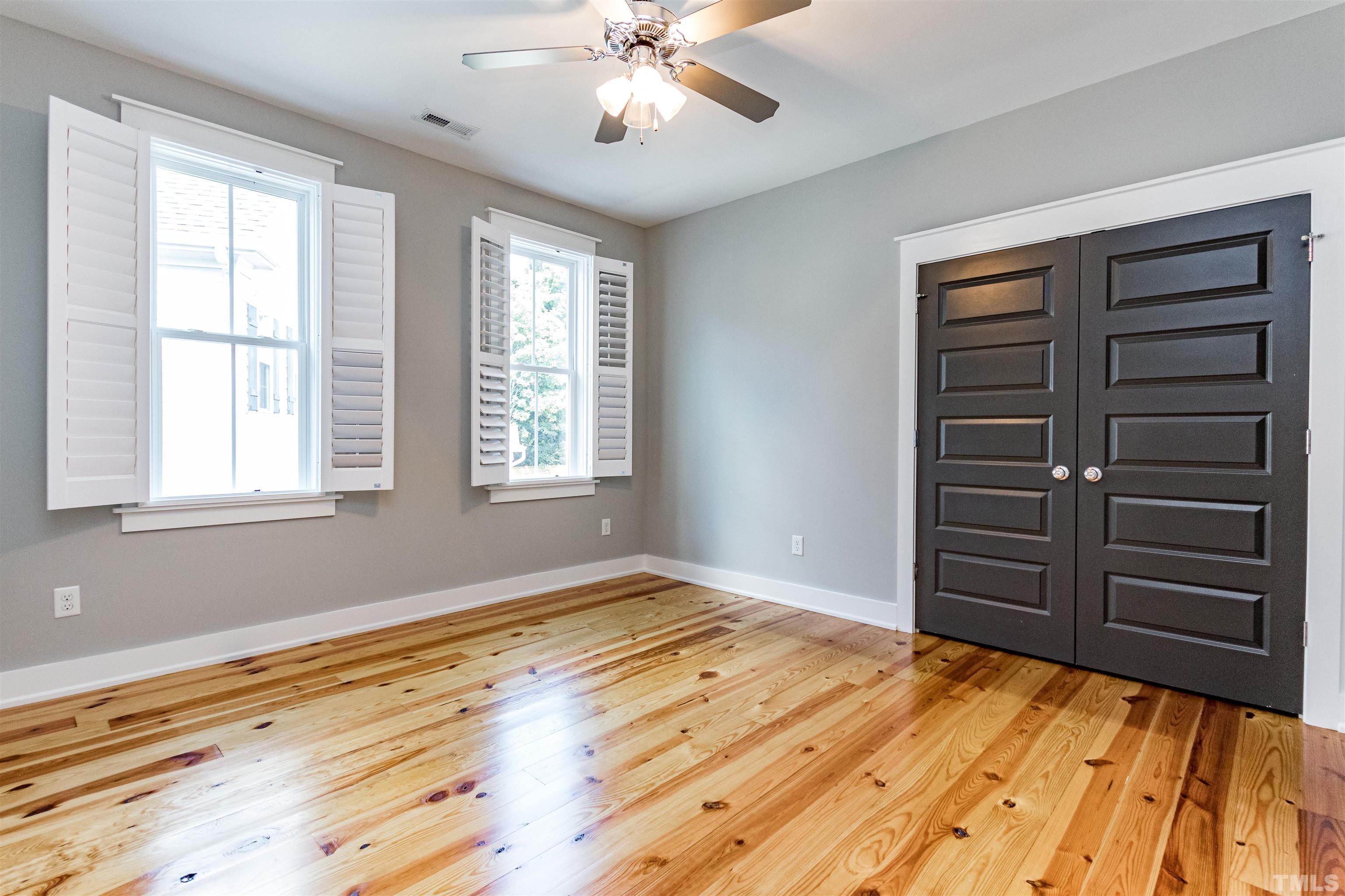610 New Road Raleigh, NC 27608 - Photo 16 of 24 a view of room with a ceiling fan and wooden floor
