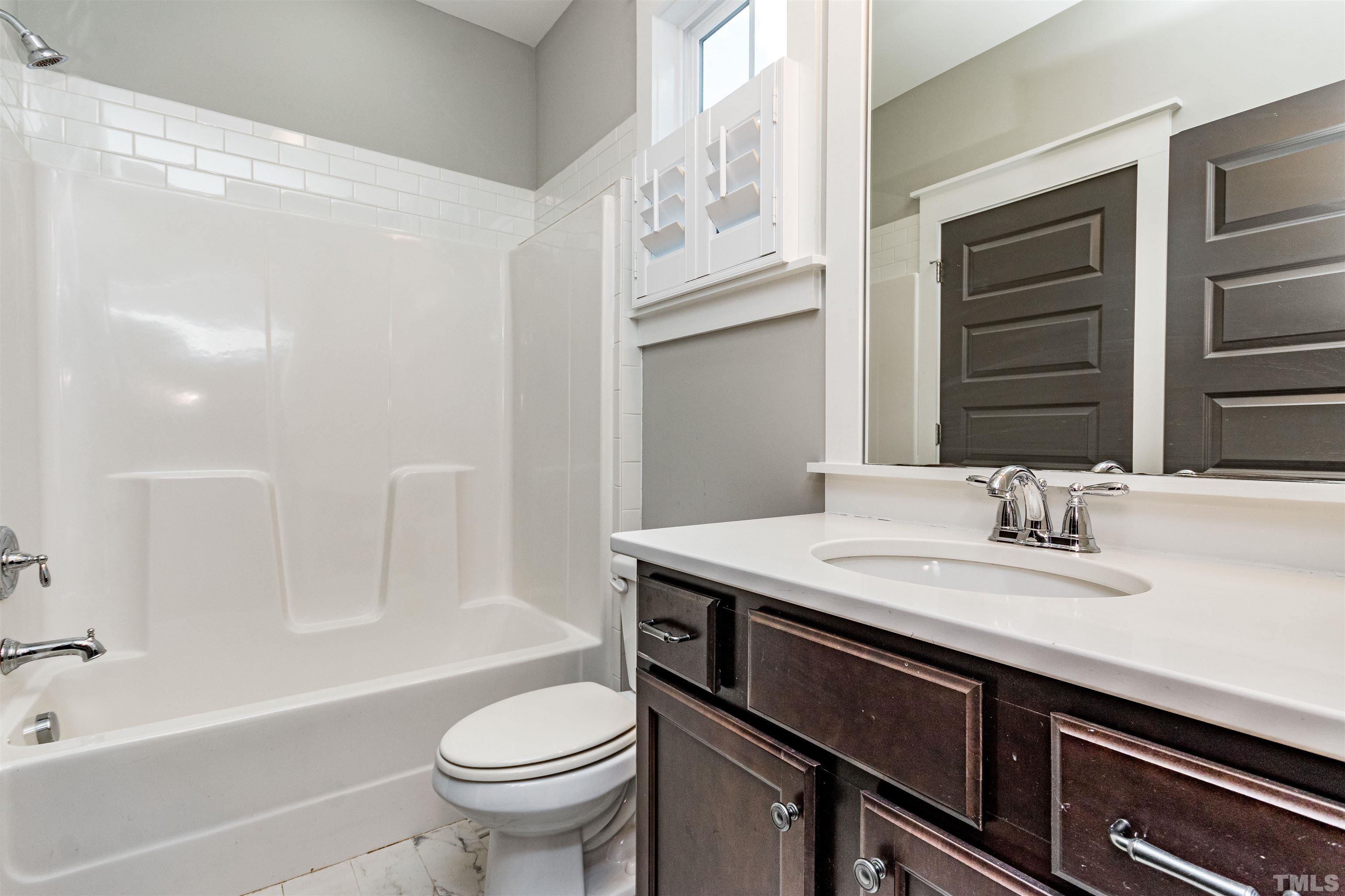 610 New Road Raleigh, NC 27608 - Photo 17 of 24 a bathroom with a granite countertop sink toilet and shower