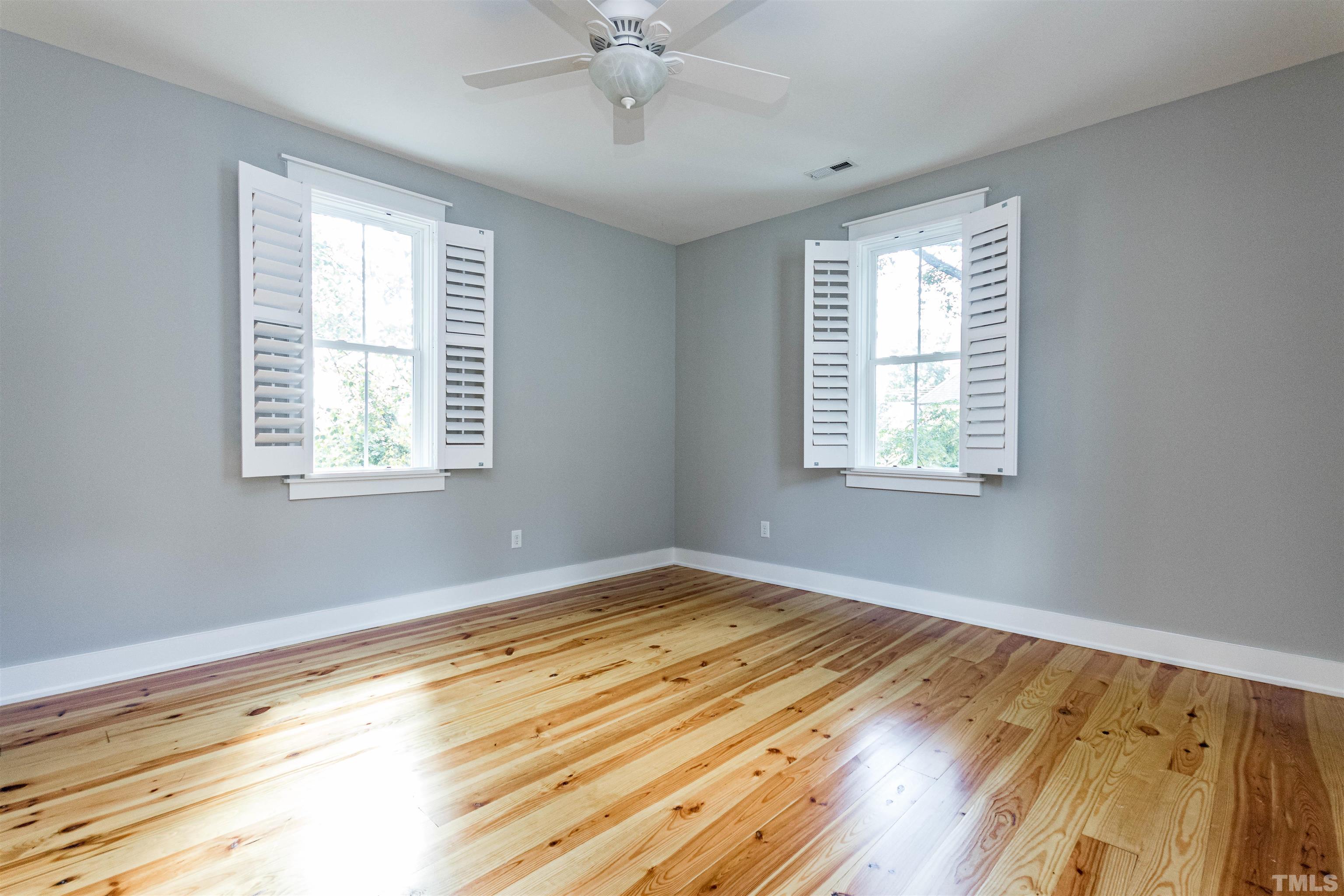 610 New Road Raleigh, NC 27608 - Photo 18 of 24 a view of an empty room with wooden floor and a window
