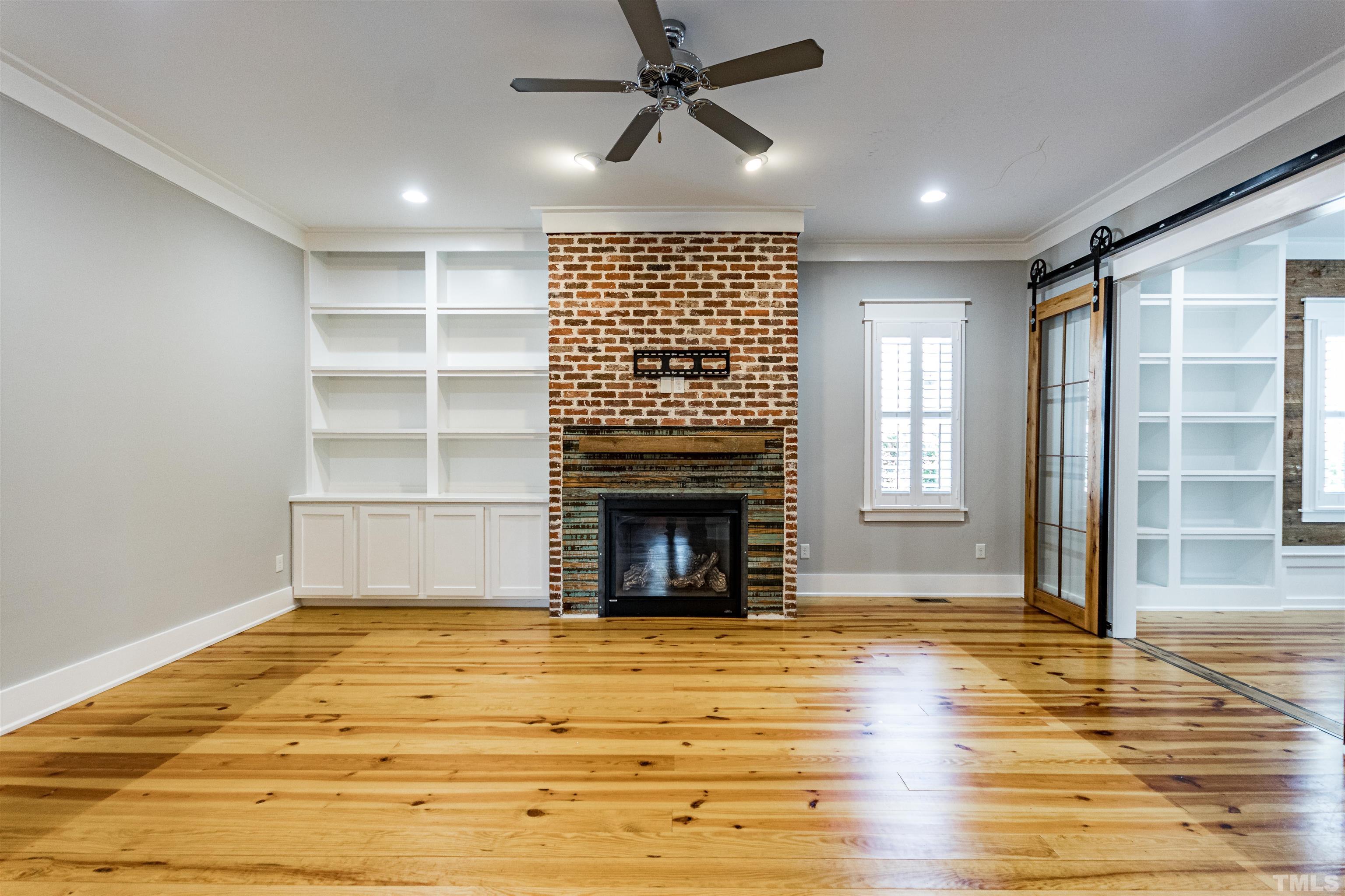 610 New Road Raleigh, NC 27608 - Photo 8 of 24 a view of an empty room with a fireplace and window