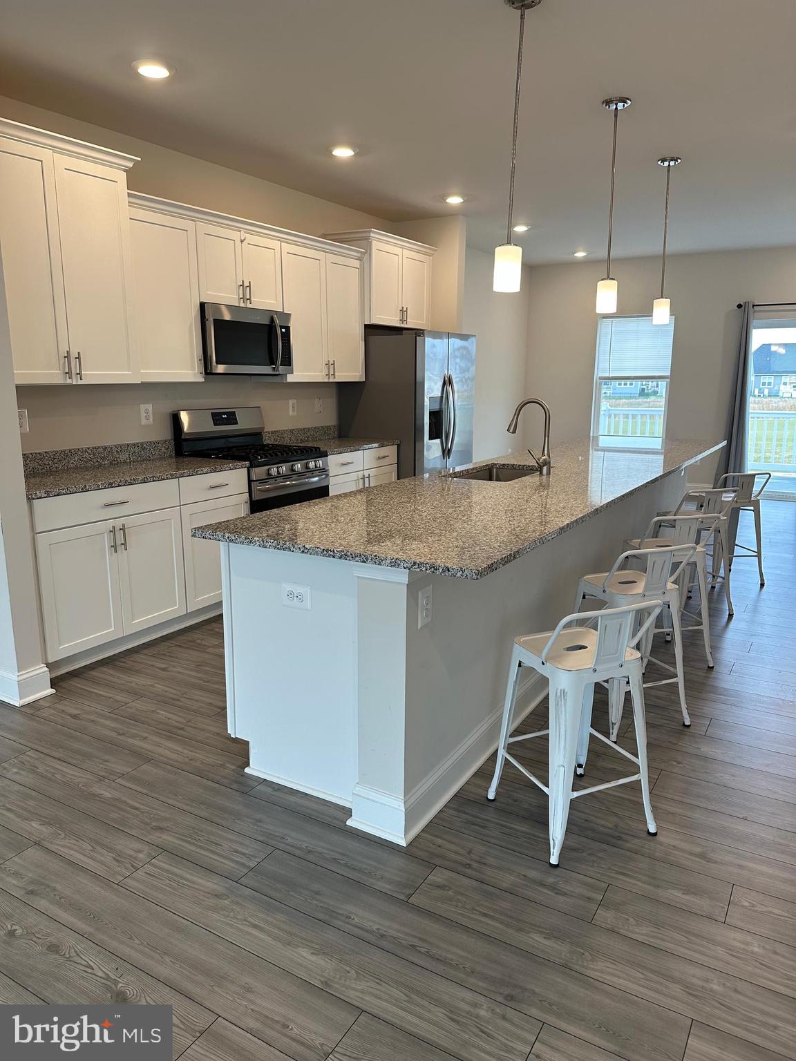 35422 Wright Way Millsboro, DE 19966 - Photo 6 of 35 a kitchen with stainless steel appliances granite countertop a table chairs sink and cabinets