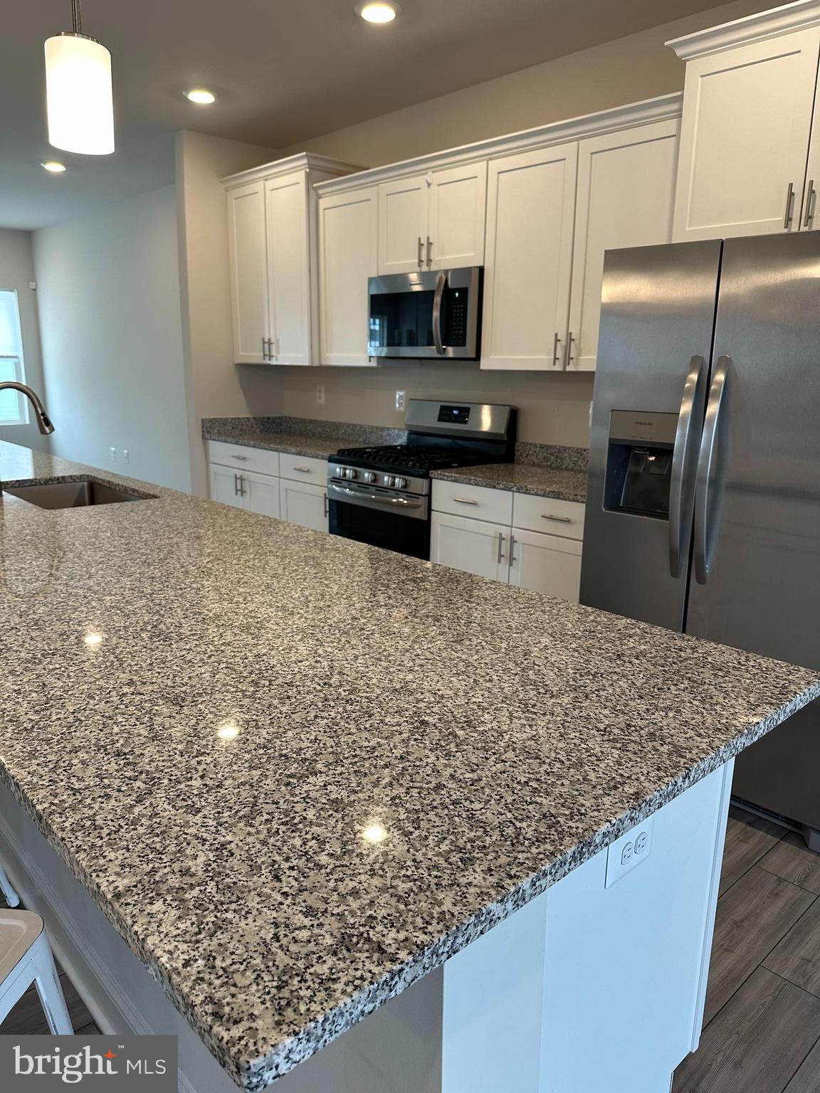 35422 Wright Way Millsboro, DE 19966 - Photo 7 of 35 a kitchen with stainless steel appliances kitchen island granite countertop a counter top and oven
