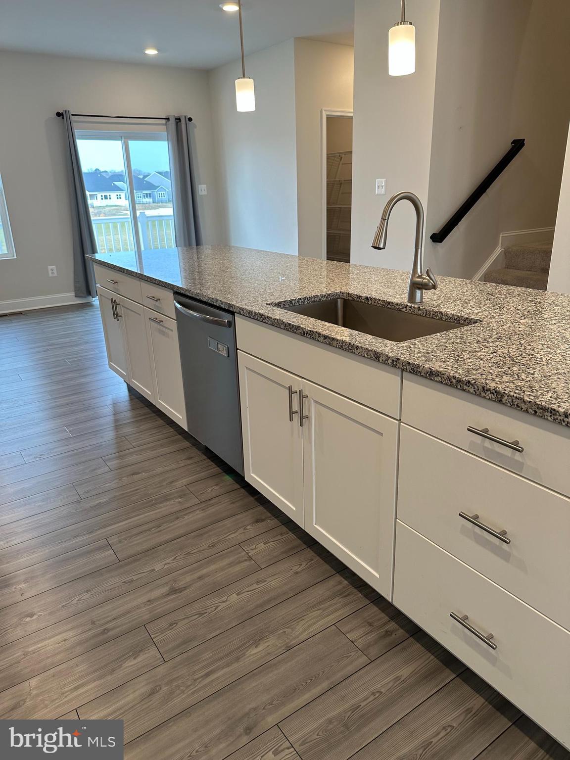 35422 Wright Way Millsboro, DE 19966 - Photo 8 of 35 a kitchen with granite countertop white cabinets and wooden floor