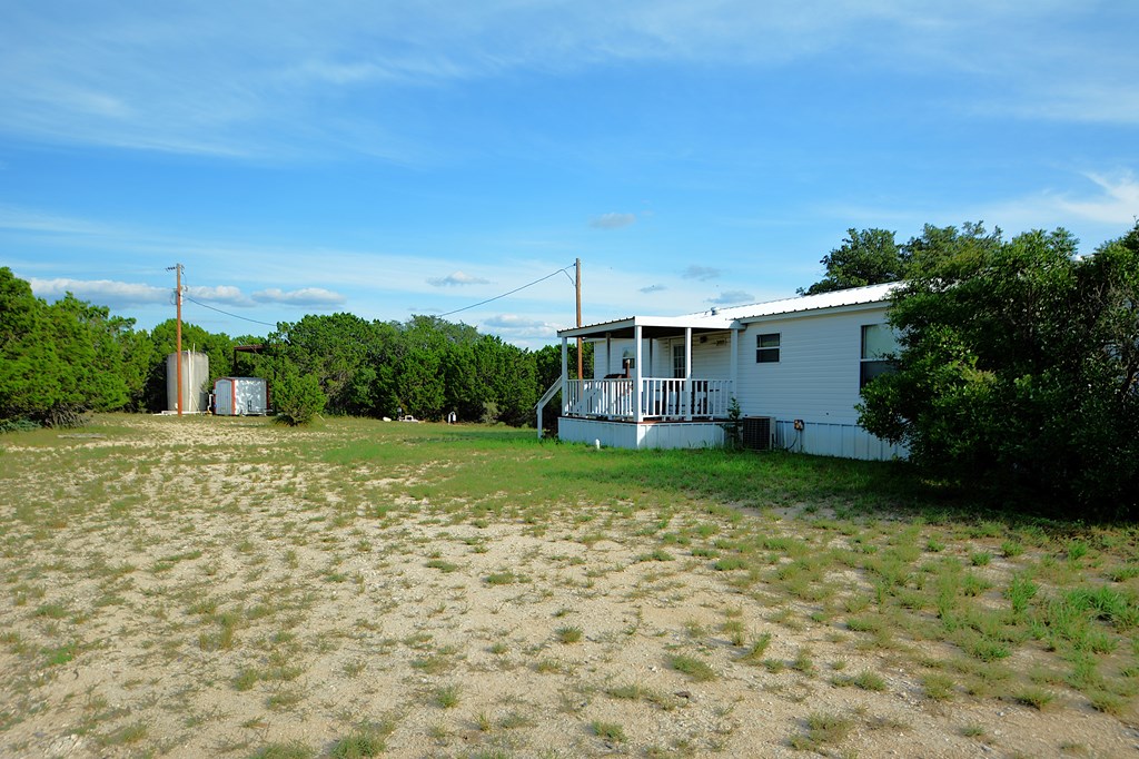 22874 Ranch Road 385 Harper, TX 78631 - Photo 25 of 31 a view of a backyard with plants and large trees
