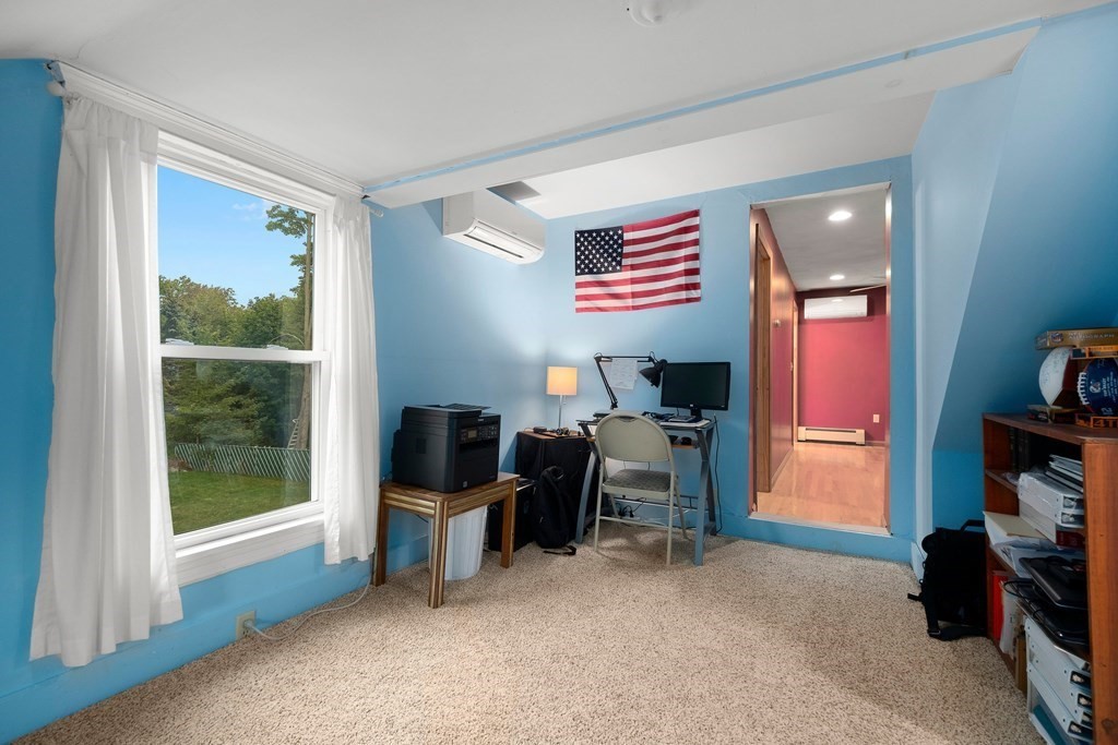102 Orange Street Reading, MA 01867 - Photo 16 of 23 a view of a workspace with furniture and a window