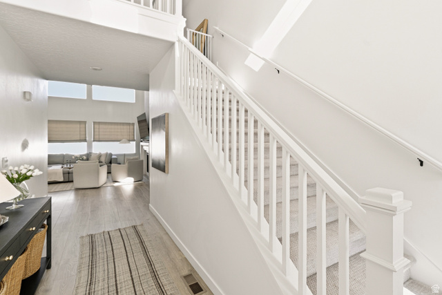 870 North Ada Loop Lehi, UT 84048 - Photo 5 of 51 Carpeted staircase with white balusters and handrail