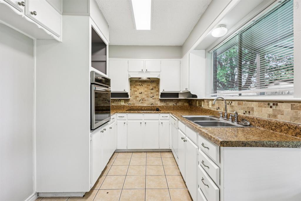 337 Apache Trail Keller, TX 76248 - Photo 11 of 36 a kitchen with granite countertop white cabinets and white appliances