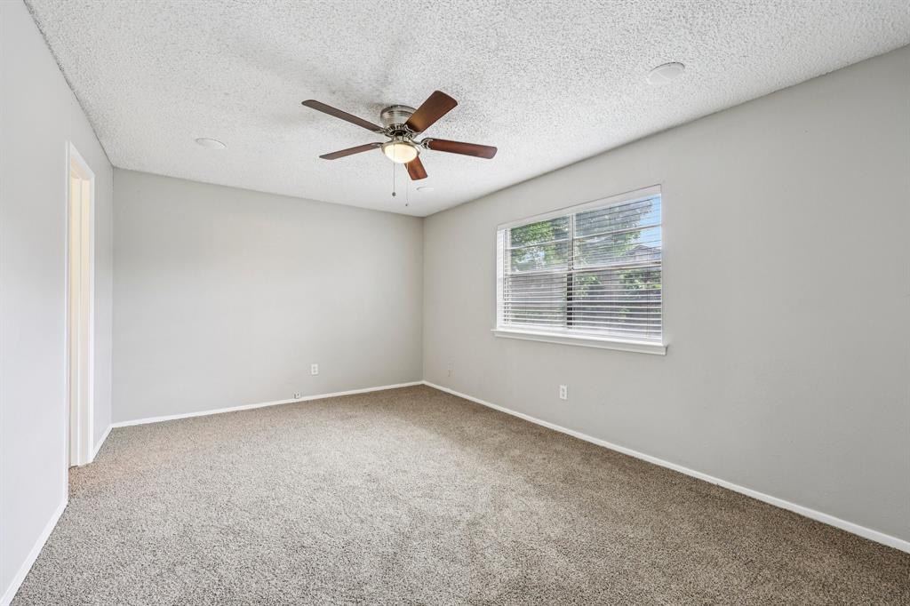 337 Apache Trail Keller, TX 76248 - Photo 17 of 36 an empty room with a window and a fan