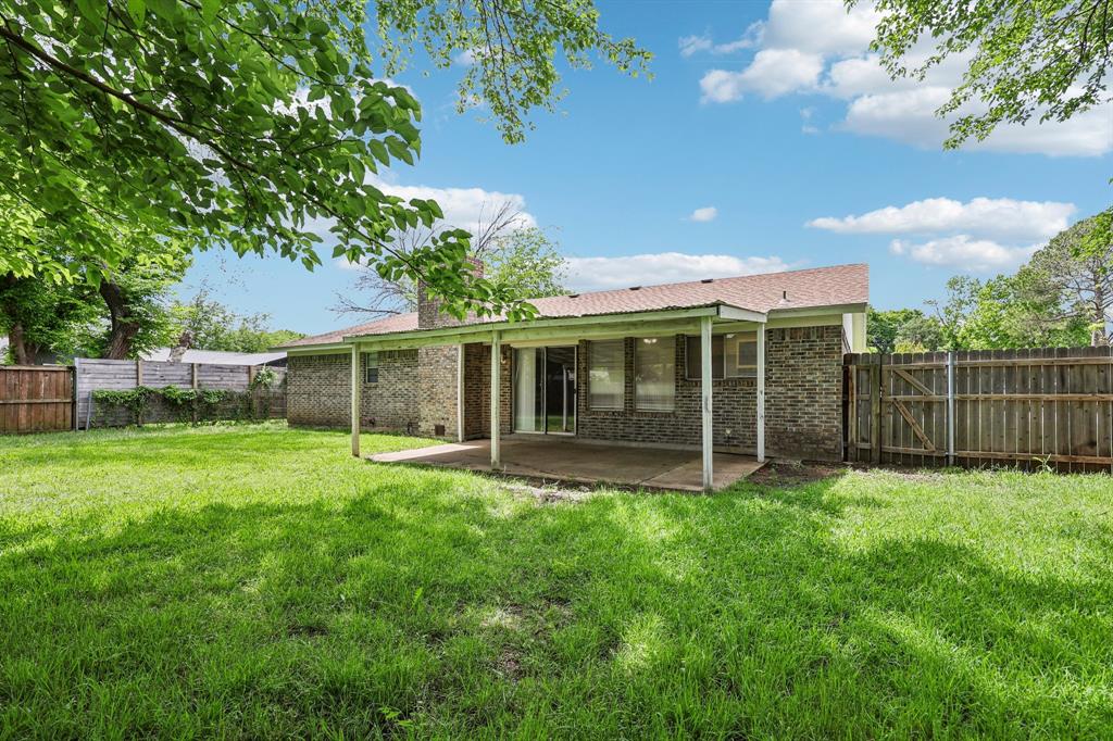 337 Apache Trail Keller, TX 76248 - Photo 23 of 36 a view of a backyard with table and chairs and large trees