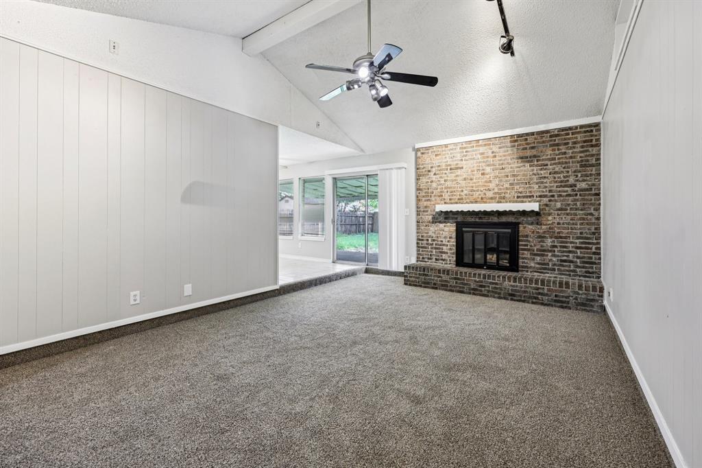 337 Apache Trail Keller, TX 76248 - Photo 5 of 36 an empty room with fireplace and fan