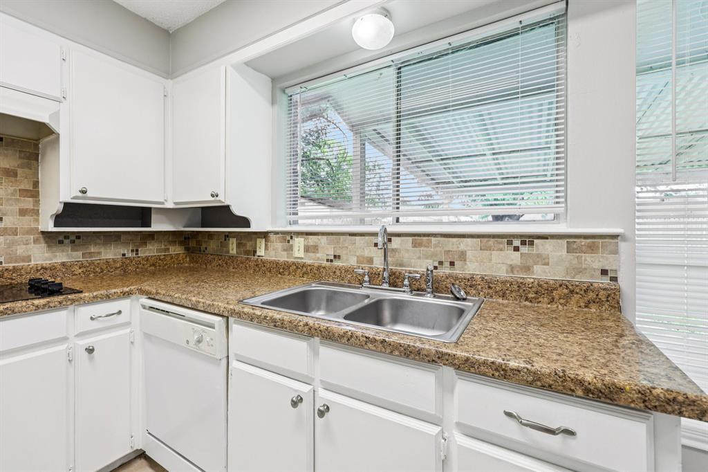337 Apache Trail Keller, TX 76248 - Photo 10 of 36 a kitchen with granite countertop white cabinets and a sink