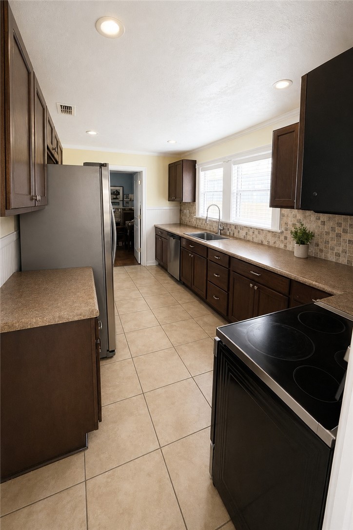 421 South Commerce Street Centerville, TX 75833 - Photo 20 of 23 a kitchen with stainless steel appliances granite countertop a sink and a stove