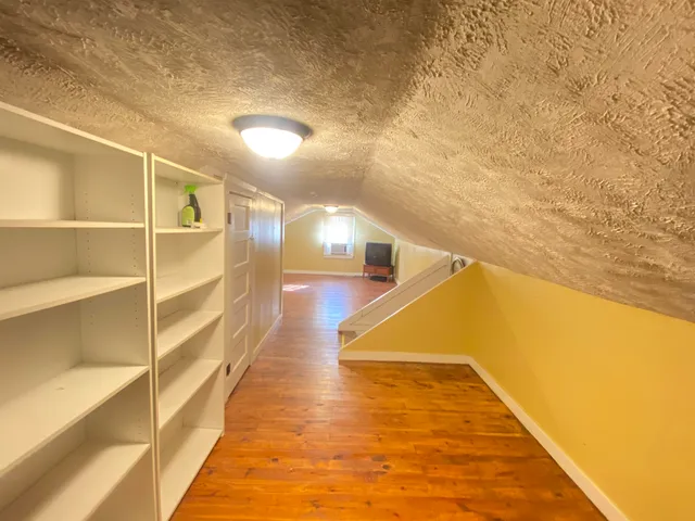 a view of a room with wooden floor