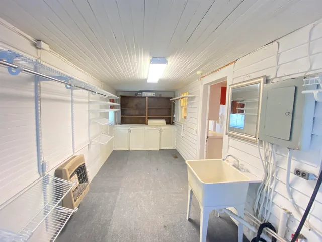 a kitchen with granite countertop a refrigerator and a sink