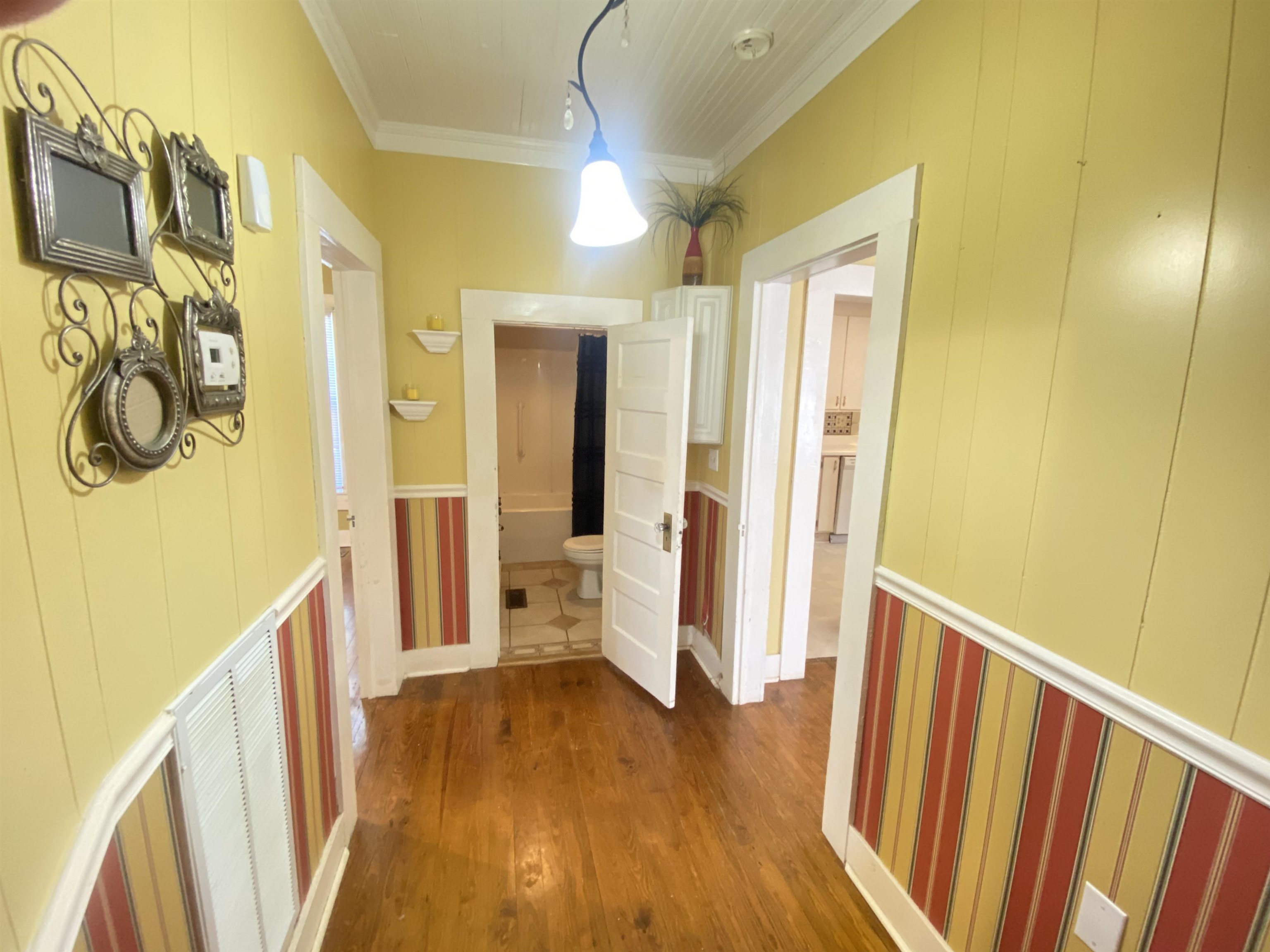 240 South Oak Street Adamsville, TN 38310 - Photo 17 of 29 a view of a hallway with wooden floor and staircase