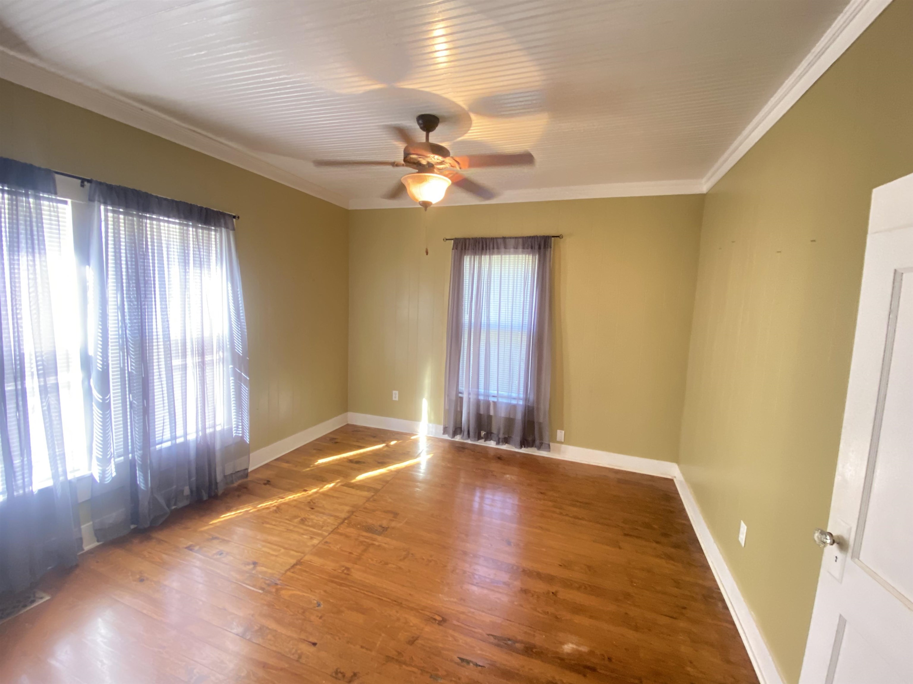 240 South Oak Street Adamsville, TN 38310 - Photo 18 of 29 a view of an empty room with window and chandelier fan