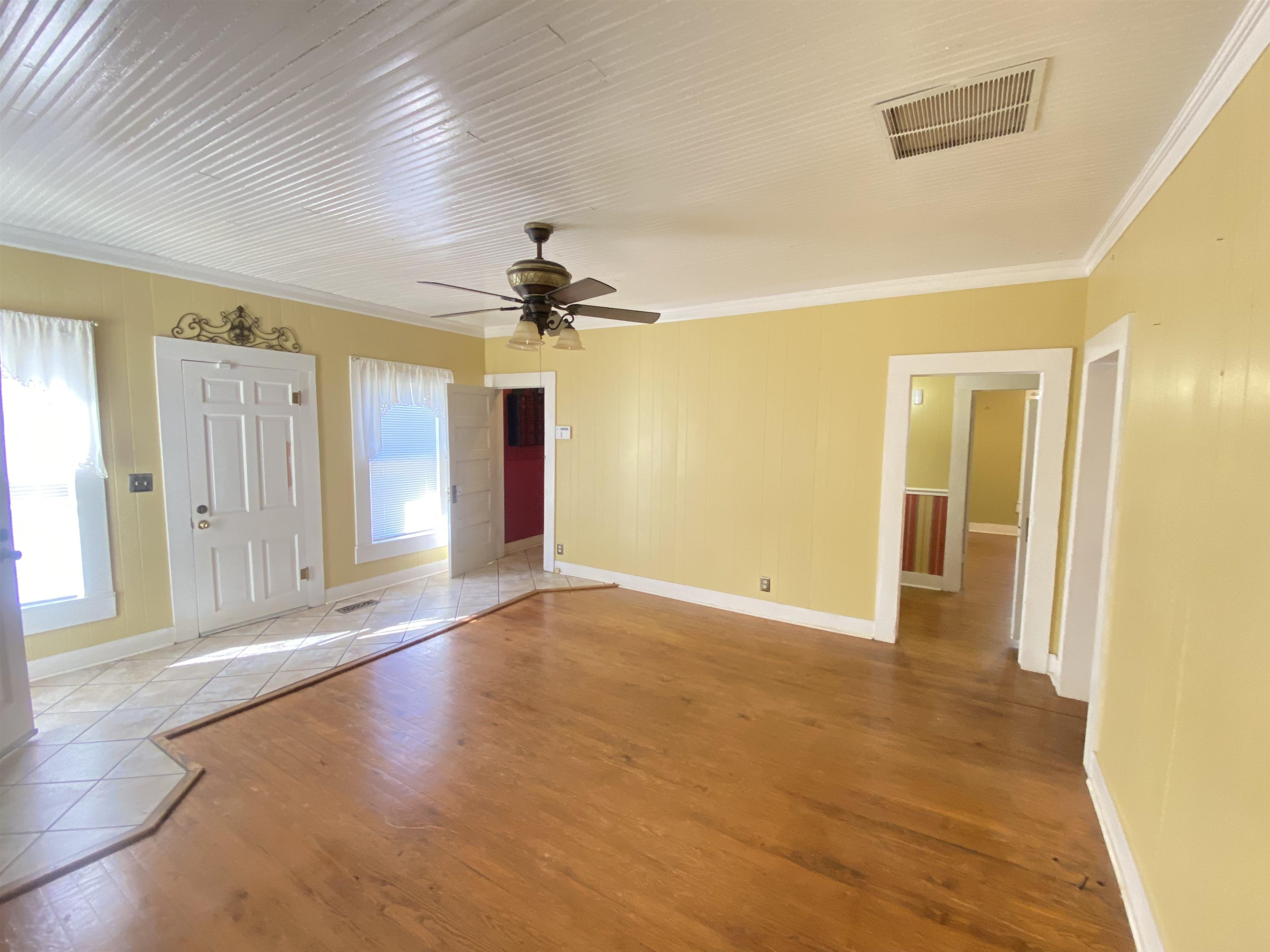 240 South Oak Street Adamsville, TN 38310 - Photo 3 of 29 a view of an empty room with window and wooden floor