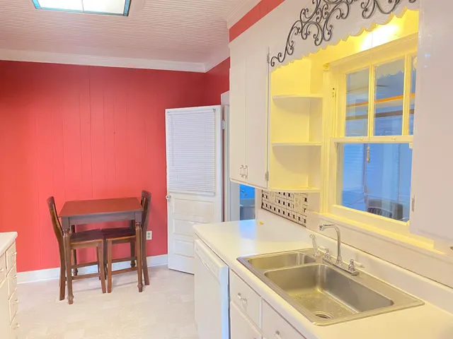 a kitchen with a sink and a chair