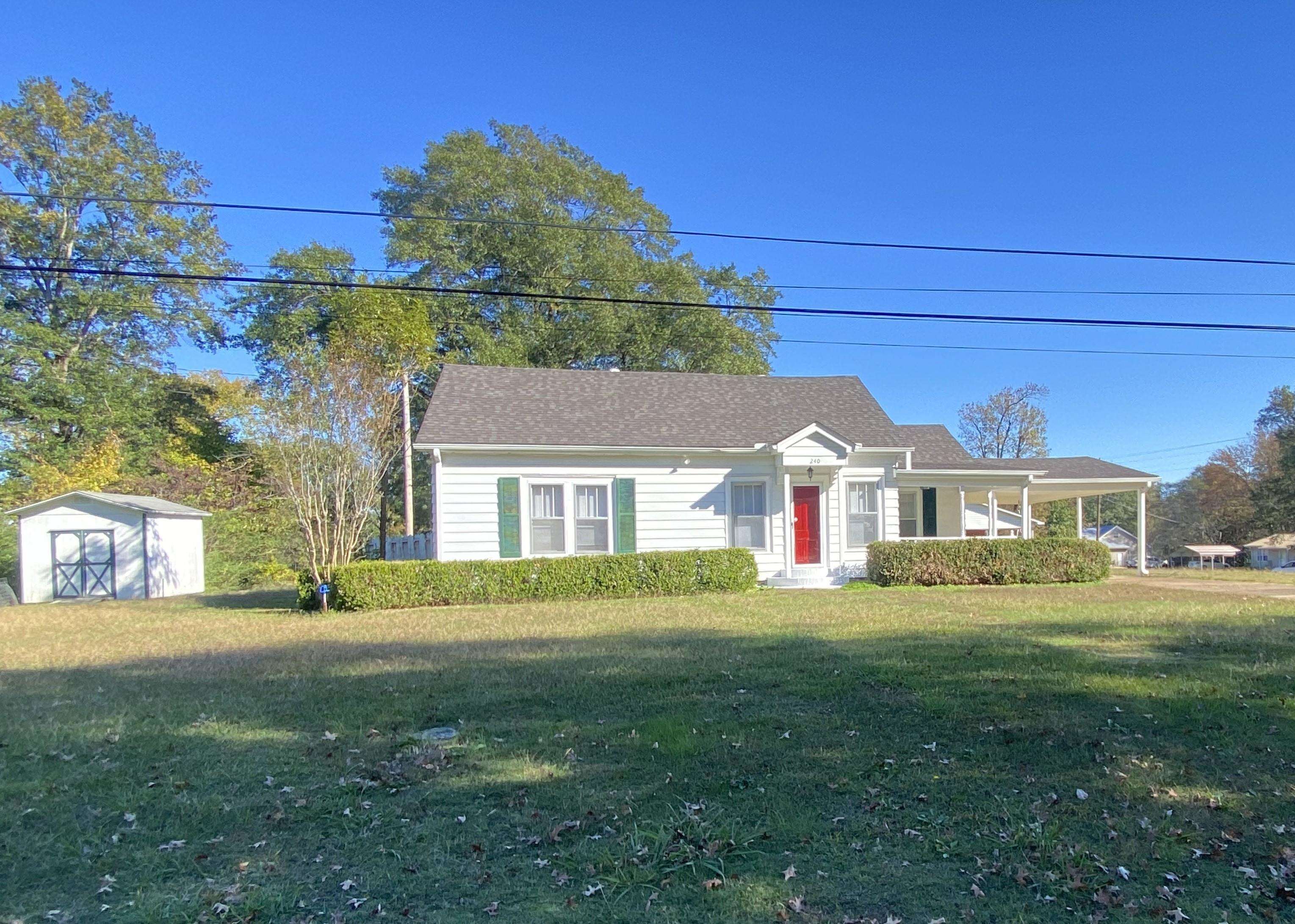 240 South Oak Street Adamsville, TN 38310 - Photo 7 of 29 a front view of a house with a yard