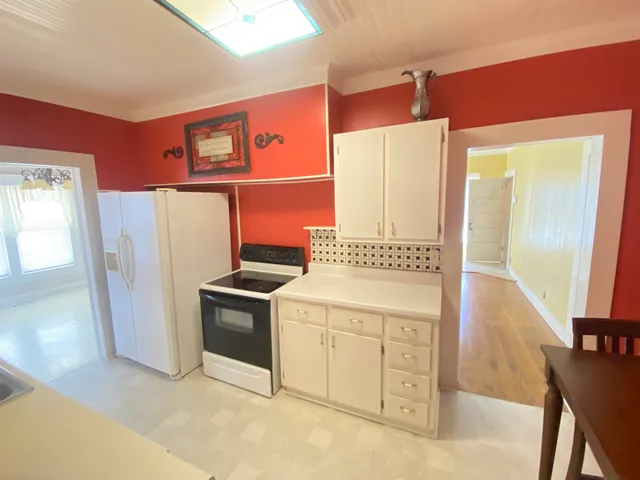 a kitchen with a refrigerator sink and stove