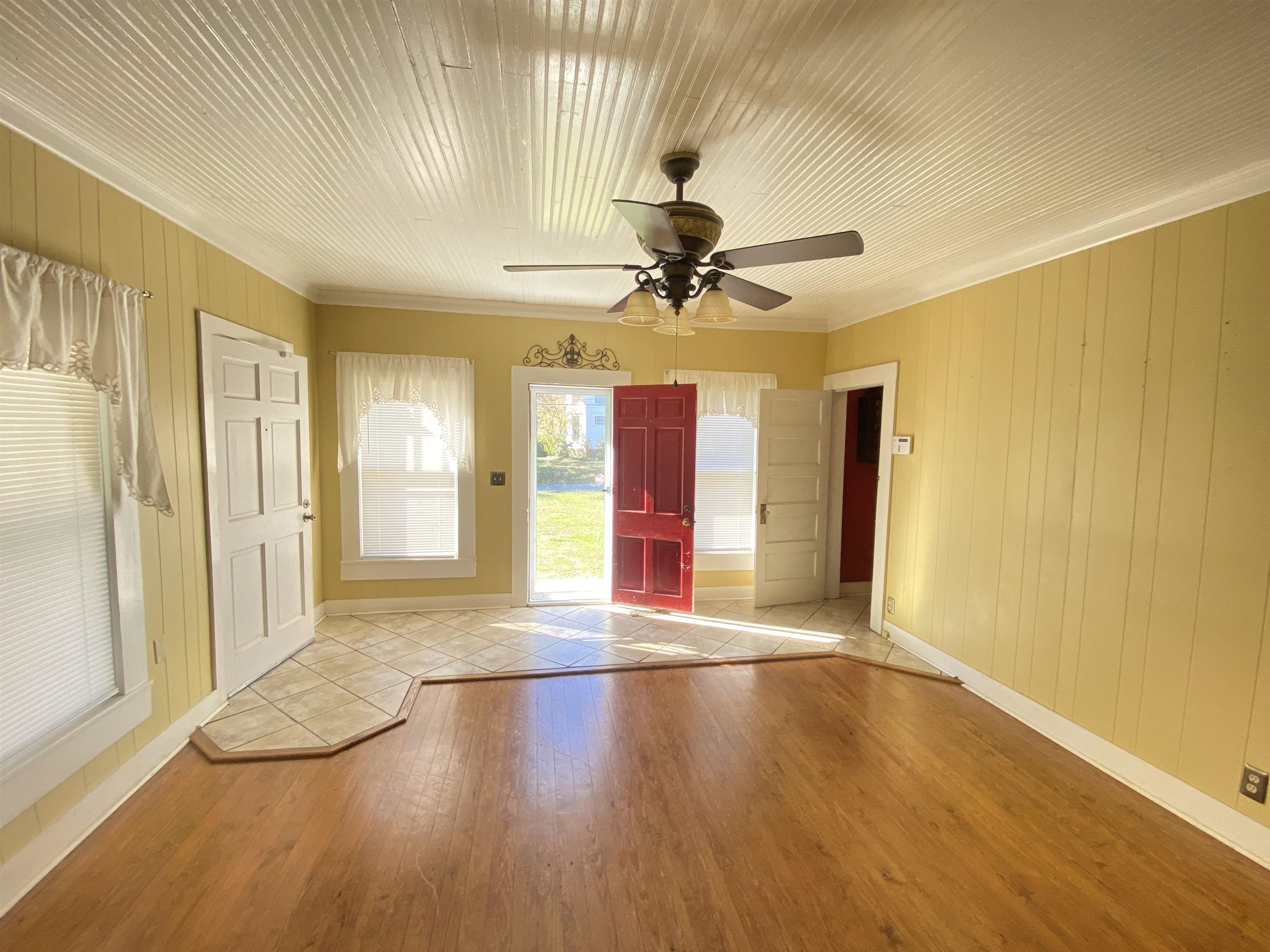 240 South Oak Street Adamsville, TN 38310 - Photo 10 of 29 a view of an empty room with window and wooden floor