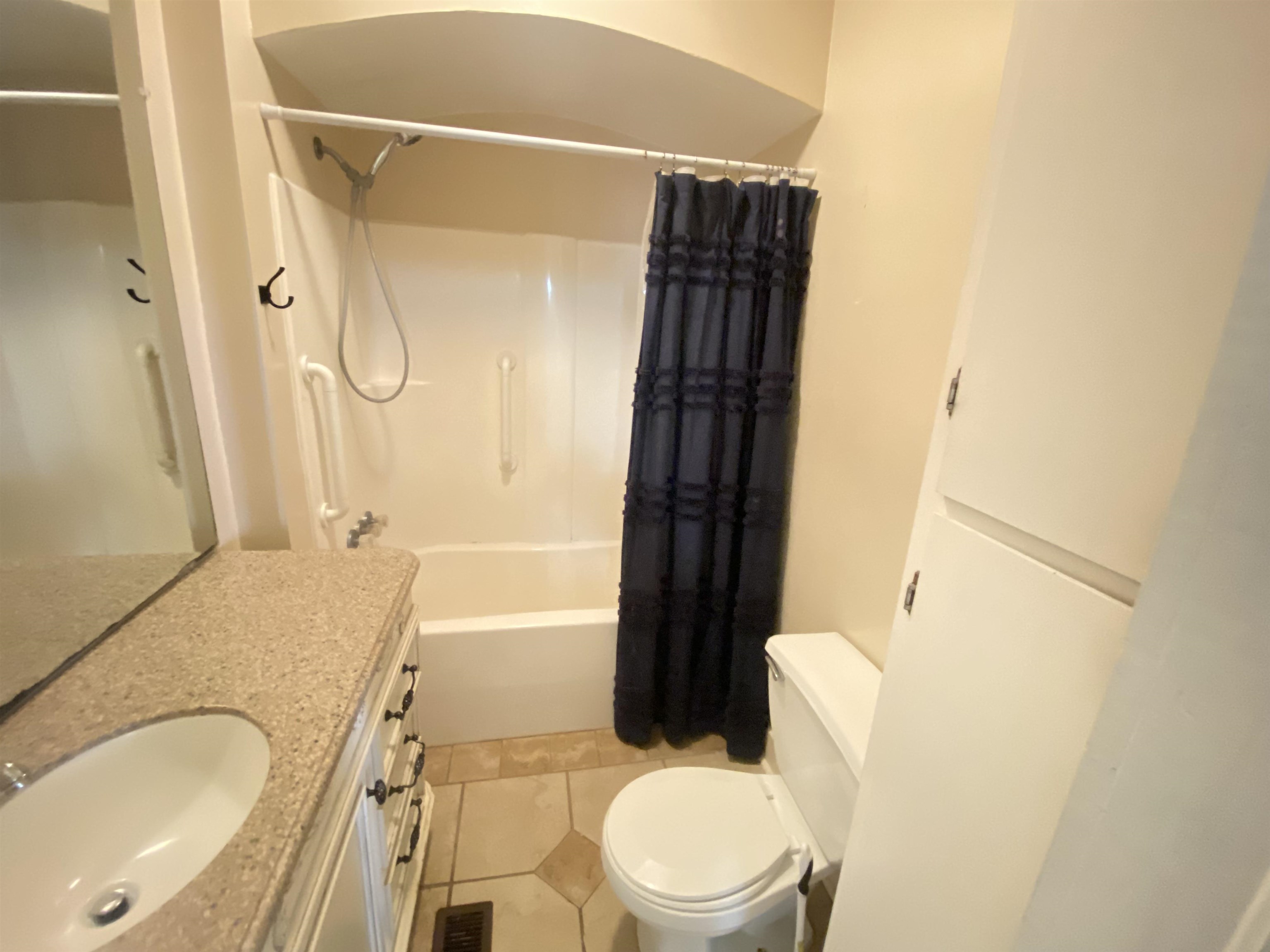 240 South Oak Street Adamsville, TN 38310 - Photo 10 of 29 a bathroom with a granite countertop sink toilet and shower