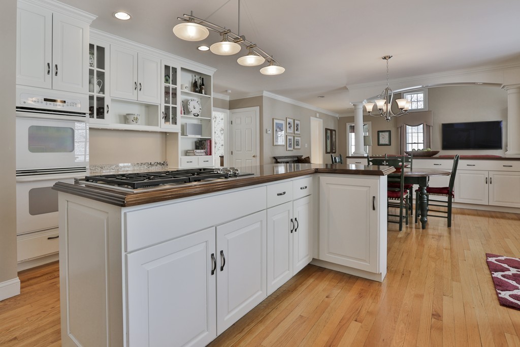 6 Powder House Lane Boxford, MA 01921 - Photo 8 of 30 a kitchen with stainless steel appliances granite countertop a stove top oven a sink dishwasher and white cabinets with wooden floor