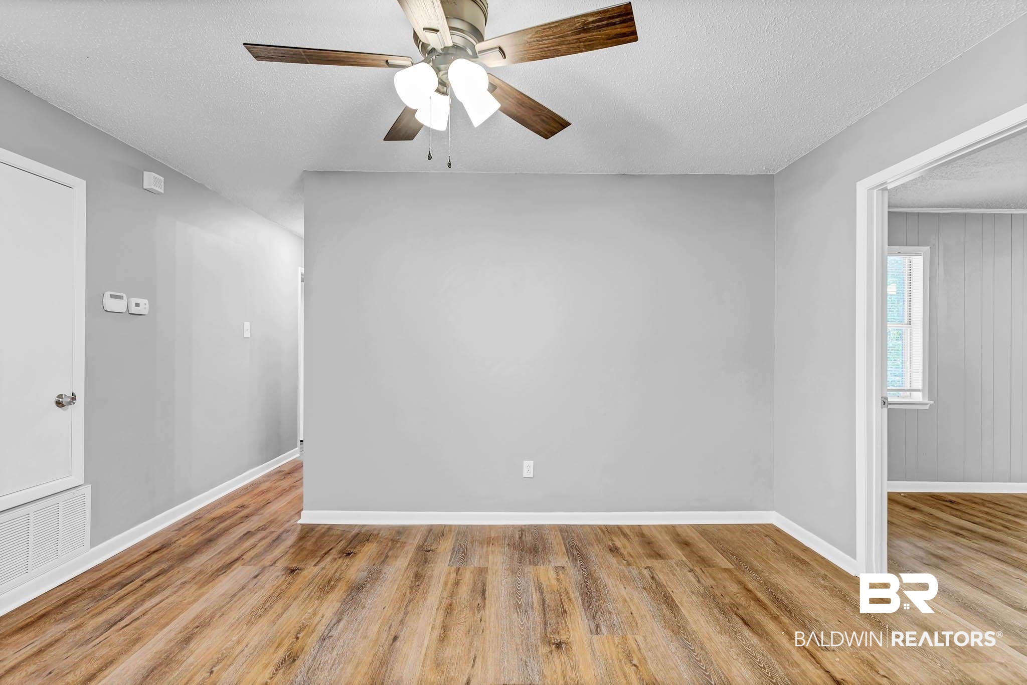 3304 Armond Drive Mobile, AL 36605 - Photo 13 of 62 Empty room with wood finished floors, a ceiling fan, and a textured ceiling