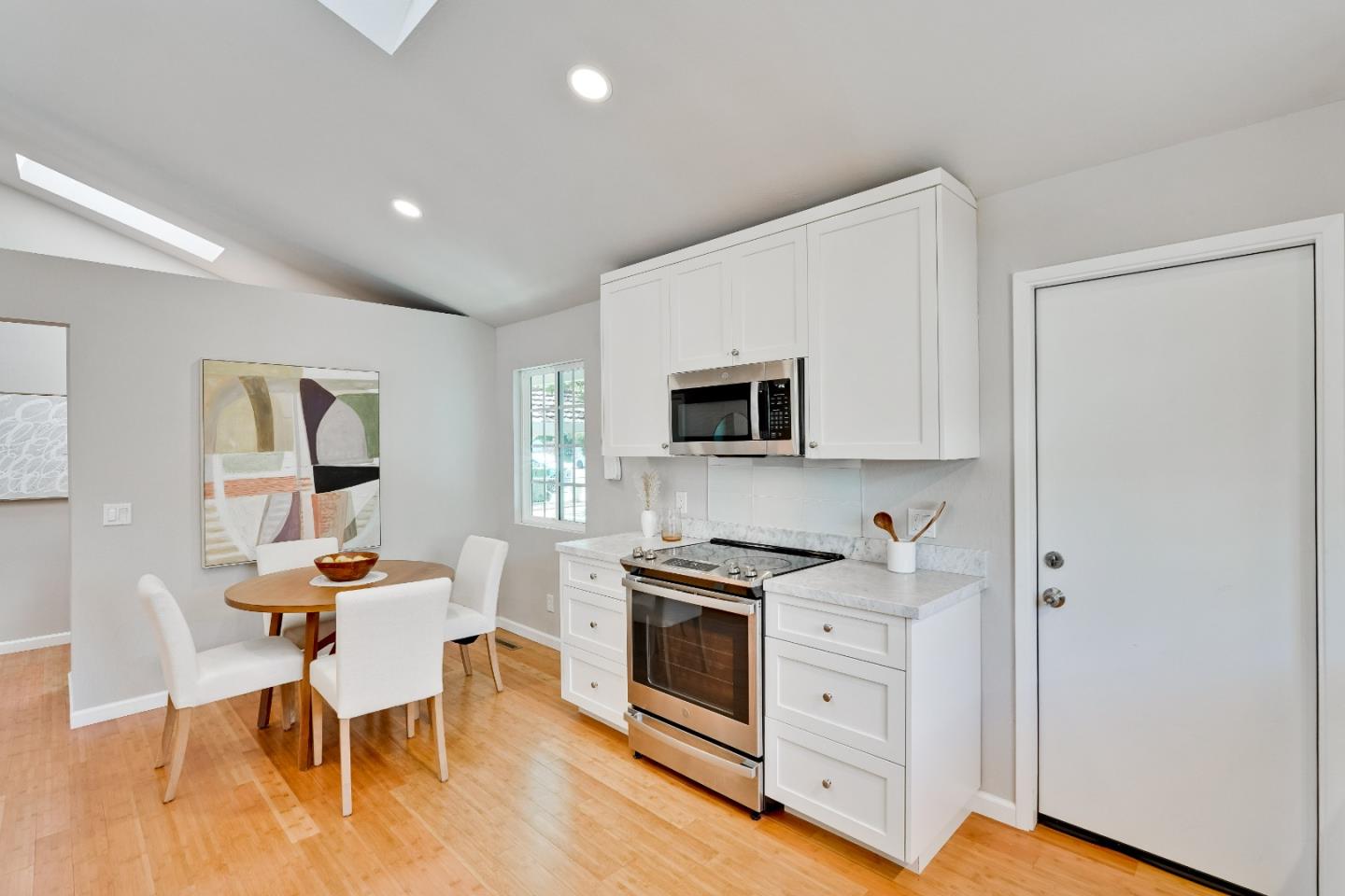 1755 Ravizza Avenue Santa Clara, CA 95051 - Photo 14 of 36 a dining room with furniture and wooden floor