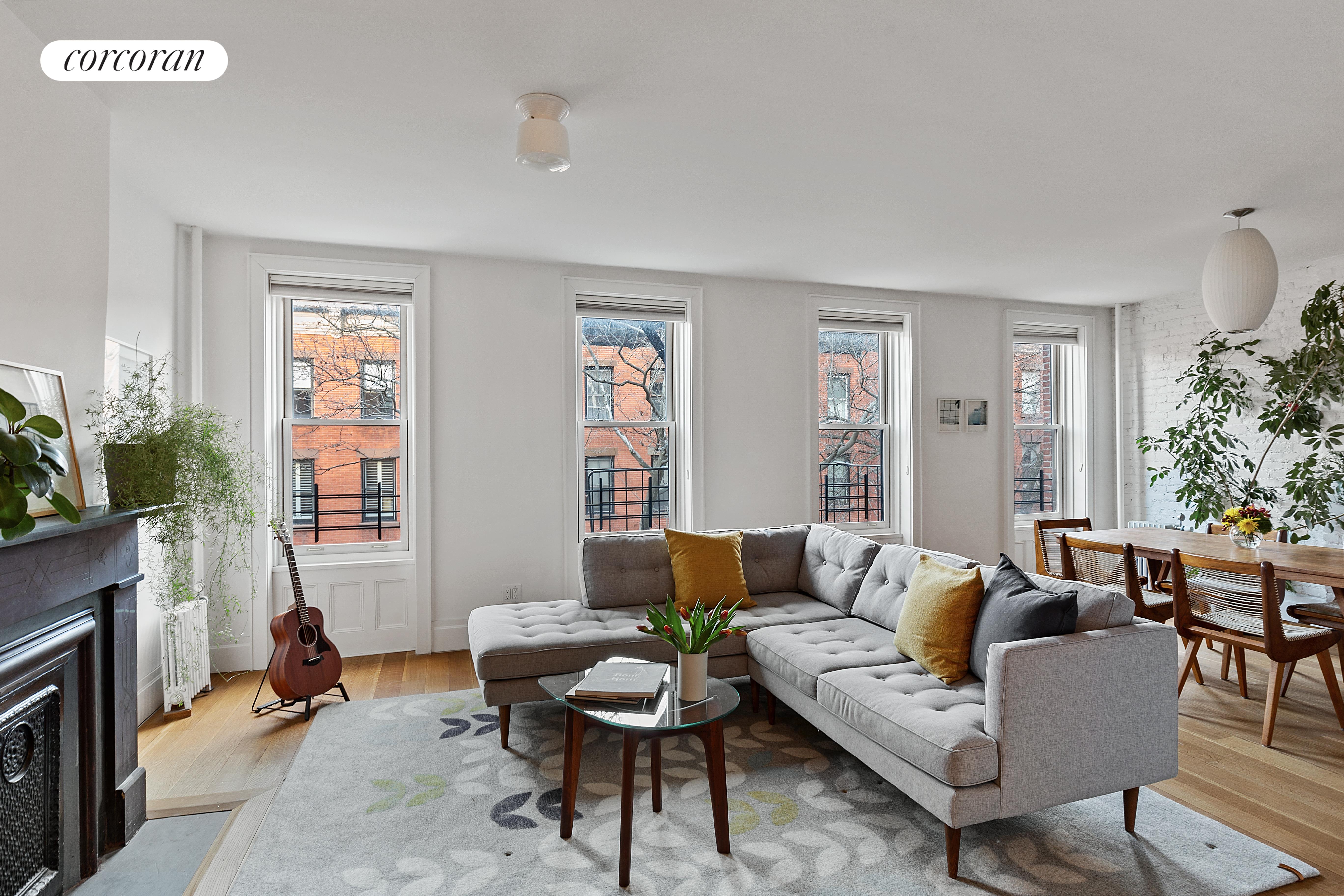242 Baltic Street, Unit 16/17 Brooklyn, NY 11201 - Photo 1 of 1 a living room with furniture and a fireplace