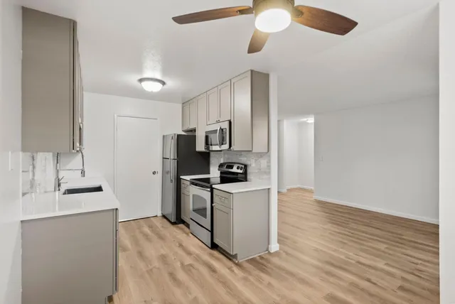 a kitchen with stainless steel appliances granite countertop a stove and a refrigerator