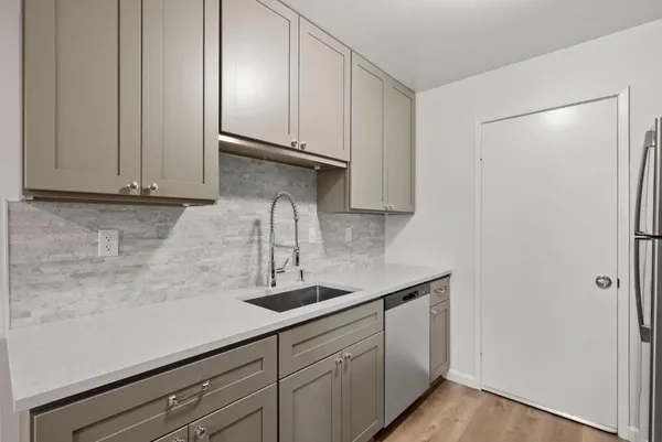 a kitchen with a sink and cabinets