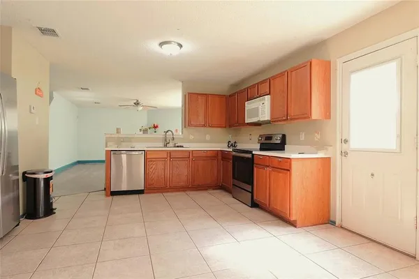 a kitchen with stainless steel appliances granite countertop a stove sink and cabinets