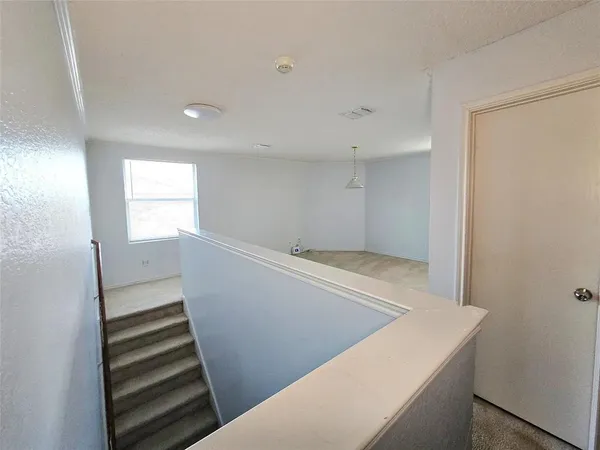 a view of wooden floor and windows in a room