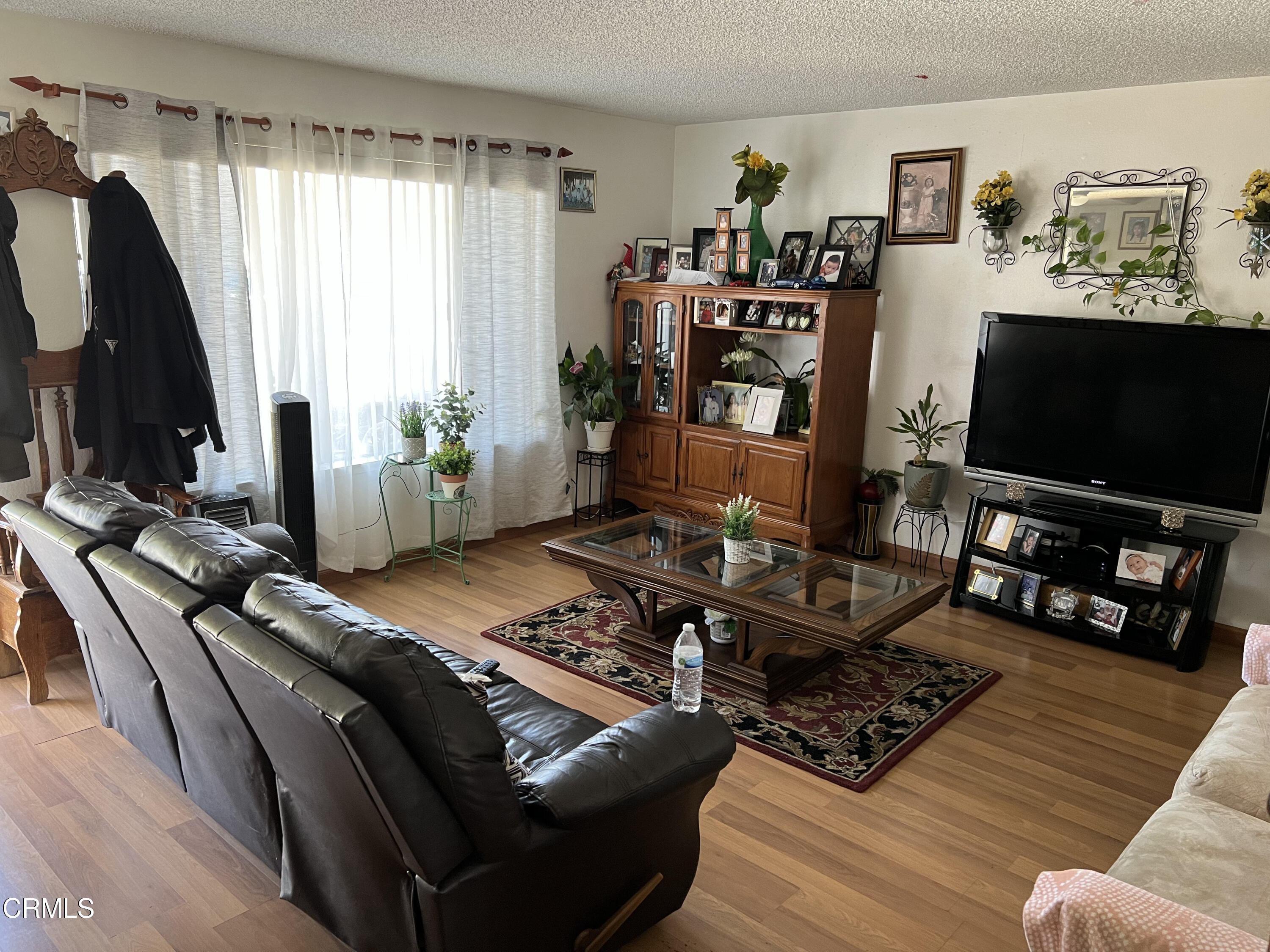 2060 Falkner Place Oxnard, CA 93033 - Photo 4 of 12 a living room with furniture and a flat screen tv