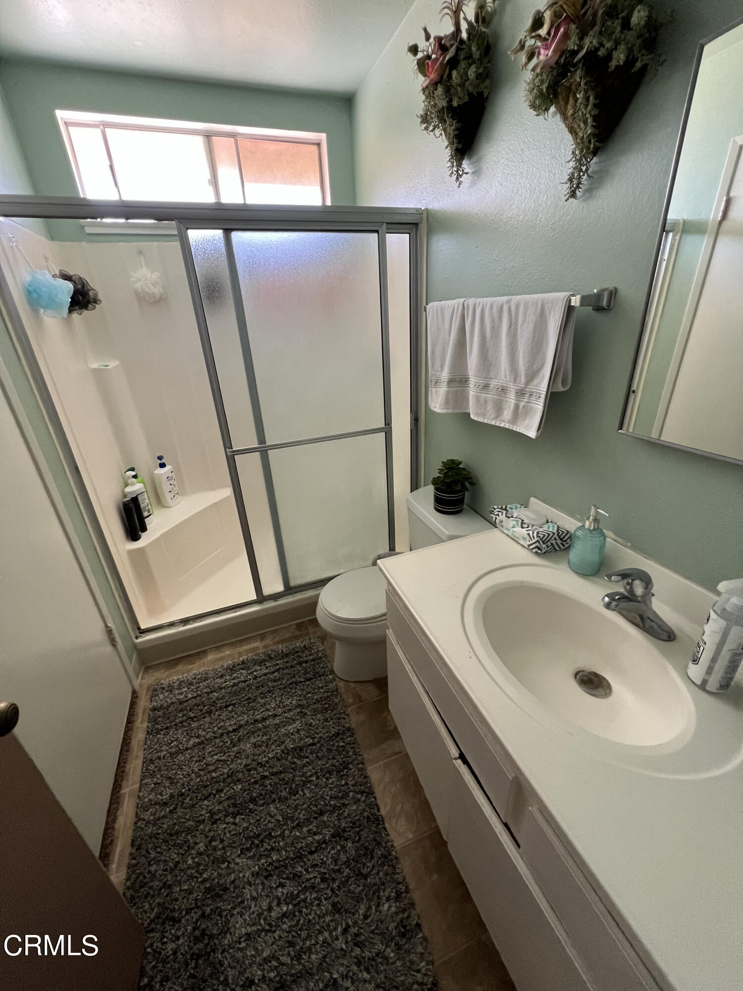 2060 Falkner Place Oxnard, CA 93033 - Photo 9 of 12 a bathroom with a sink and mirror with toilet