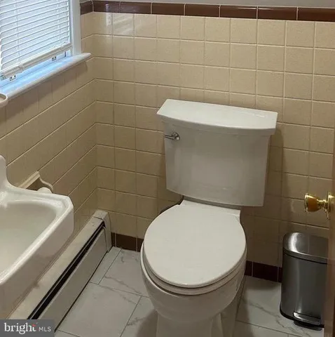 a bathroom with a toilet and a sink