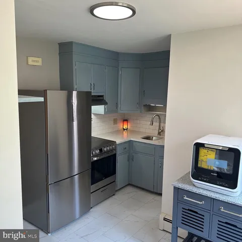 a kitchen with stainless steel appliances a refrigerator stove and microwave