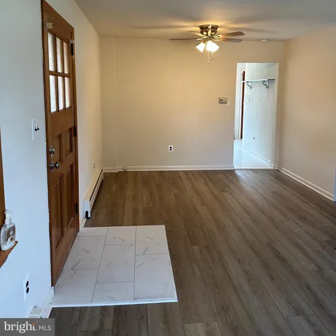 wooden floor in an empty room with a window